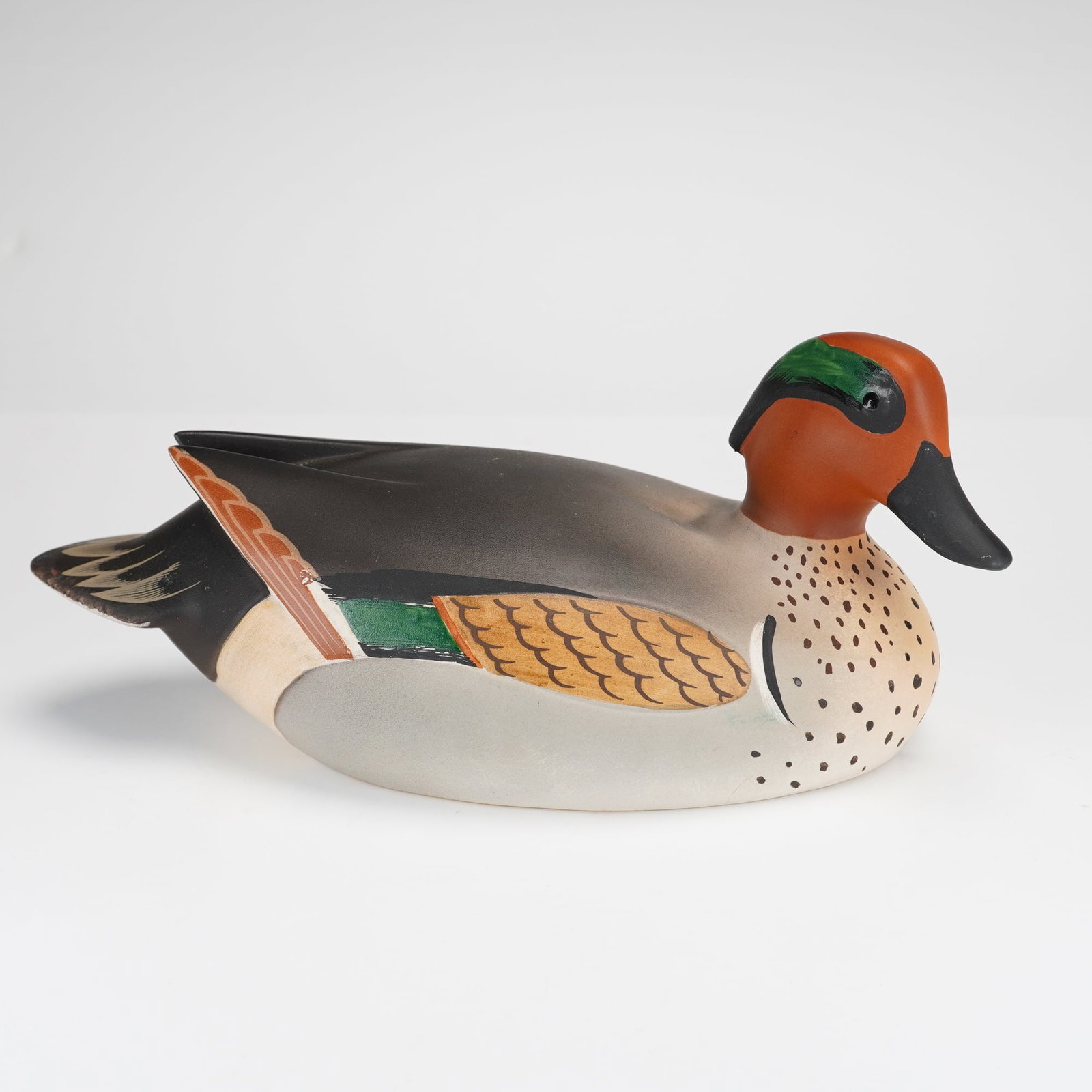 Royal Doulton Figurine, Green Winged Teal HN3520: From the A Wildfowl Counterfeit series. The piece features a matte, hand-painted finish with realistic plumage details in shades of chestnut, green, gray, and black. The underside is fully marked with