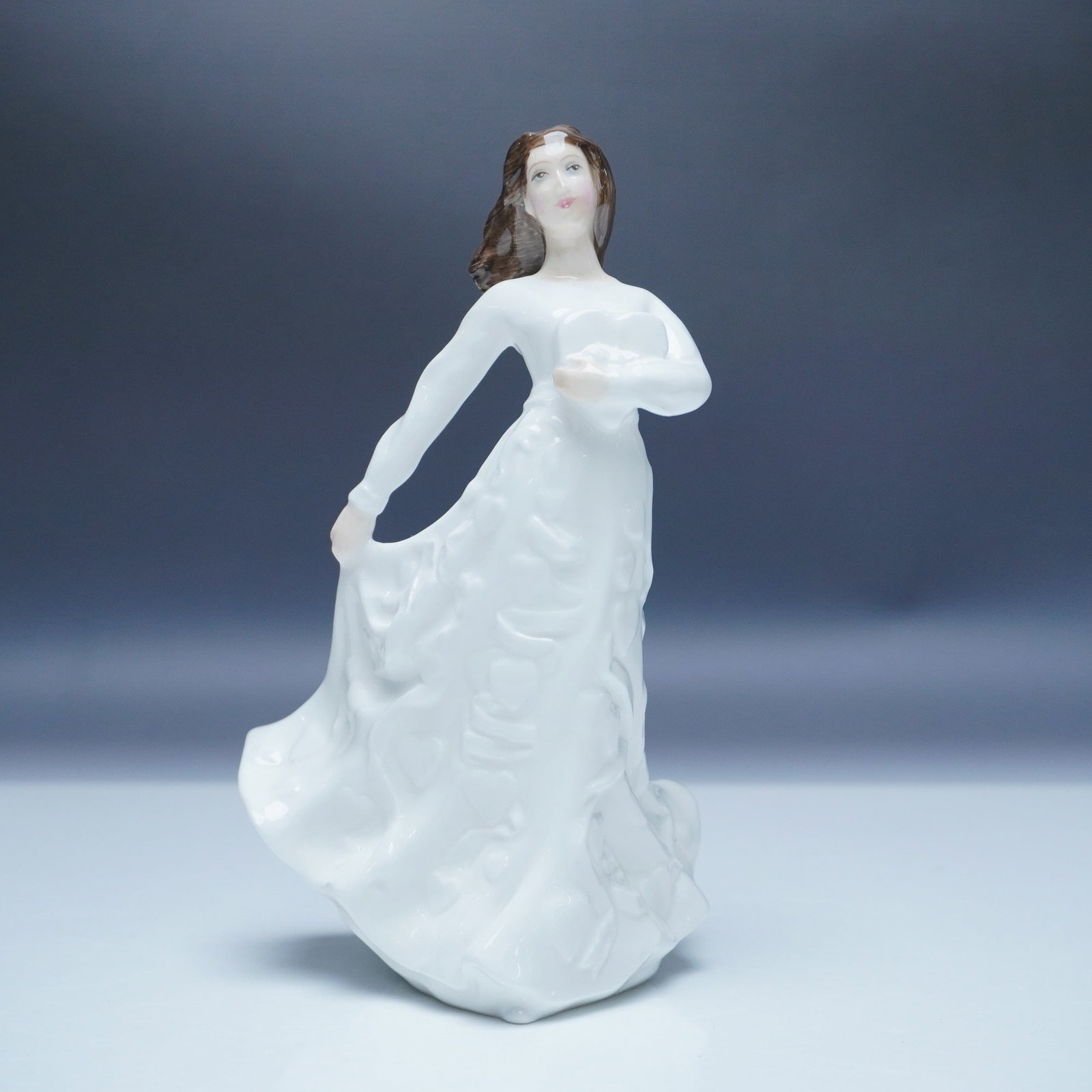 Royal Doulton Figurine, Loving Thoughts HN3948: Royal Doulton, renowned for its fine bone china and collectible figurines, presents Loving Thoughts (HN3948), a beautifully detailed porcelain piece introduced in 1997. This elegant figurine captures