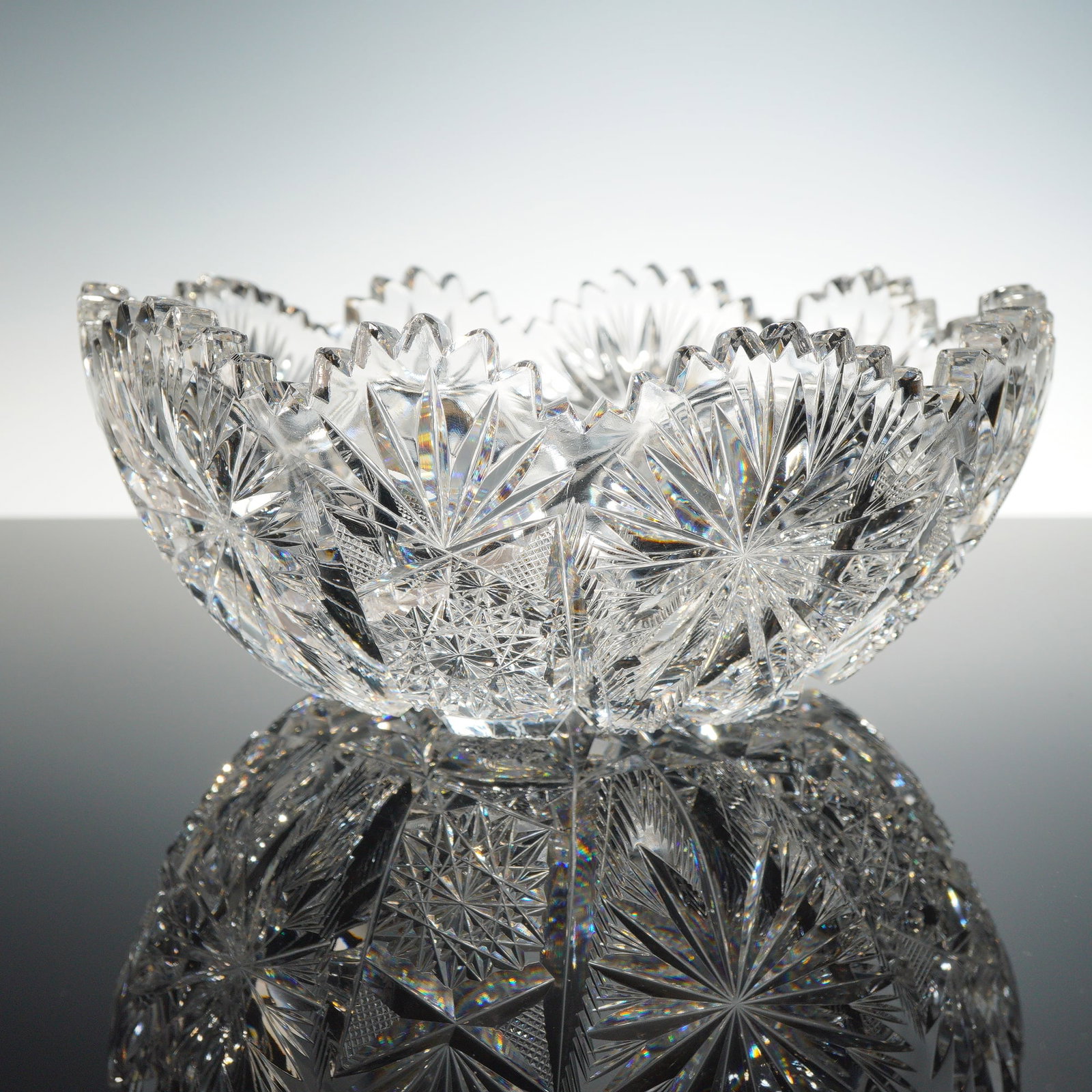 American Brilliant Period Cut Glass Pinwheel Centerpiece Bowl: This is a large and heavy centerpiece bowl from the American Brilliant Period (ABP), dating approximately from 1876 to 1916. The bowl features an exceptionally intricate and deeply cut geometric patte