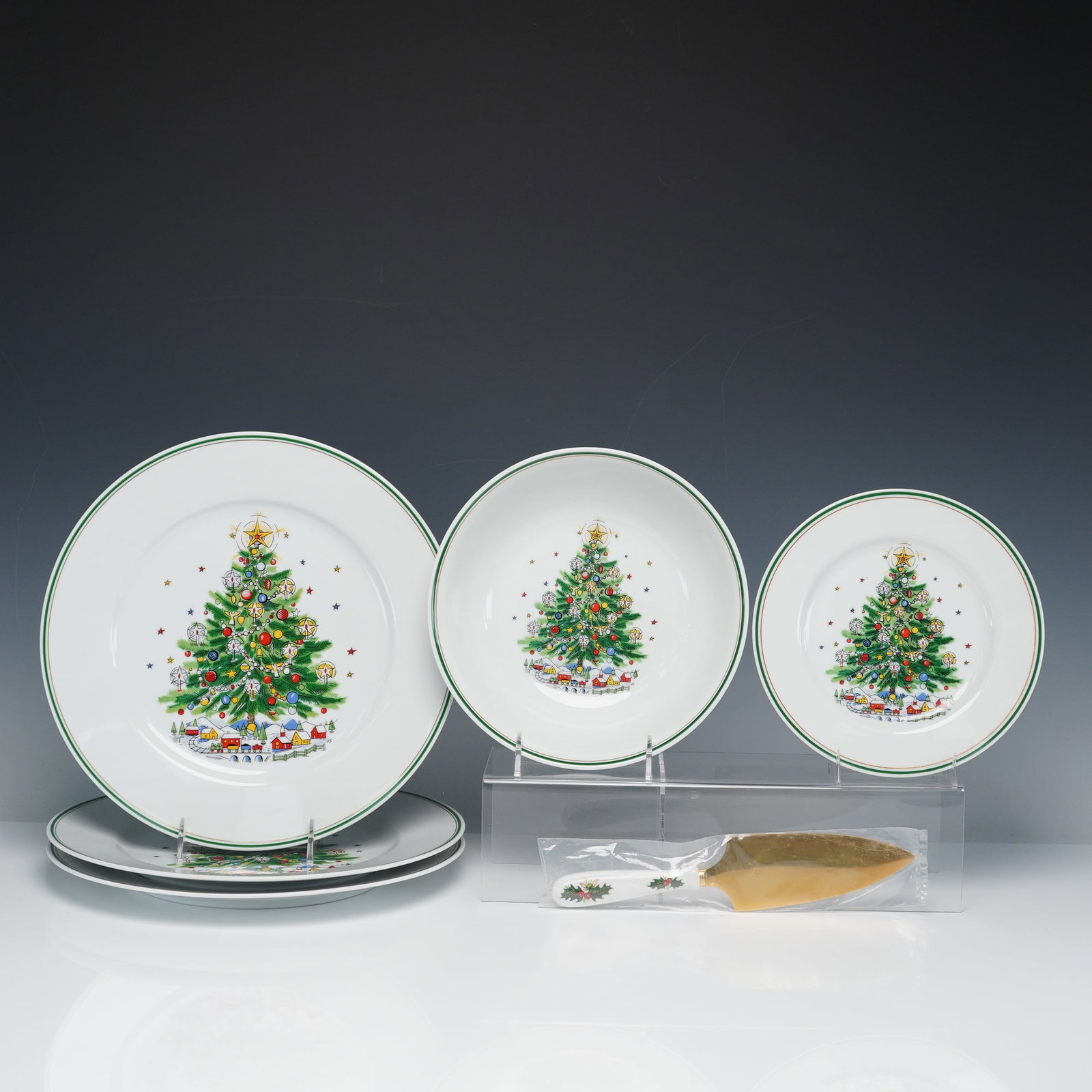 7pc Salem Christmas Eve and Queens Yuletide Serveware Set: A coordinated 7-piece holiday-themed group including porcelain tableware from Salem's Christmas Eve pattern and a Rosina-Queens Yuletide pie and cake server. This lot includes 3 round platters, 1 sala