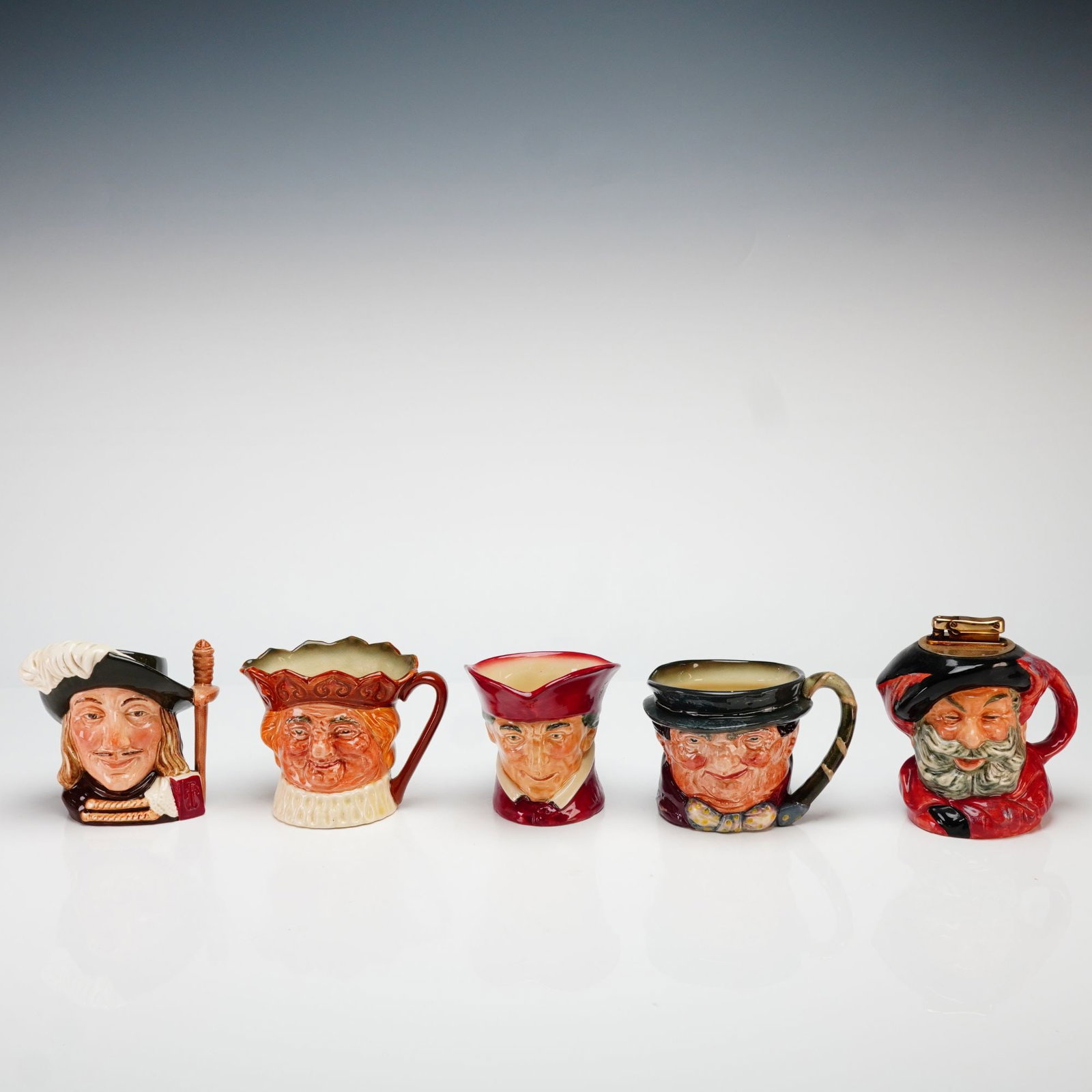 Royal Doulton Character Jugs and Falstaff Table Lighter Collection: This collection consists of five Royal Doulton hand-painted glazed earthenware character items manufactured in Burslem, England. The set features four small character jugs and one table lighter, each