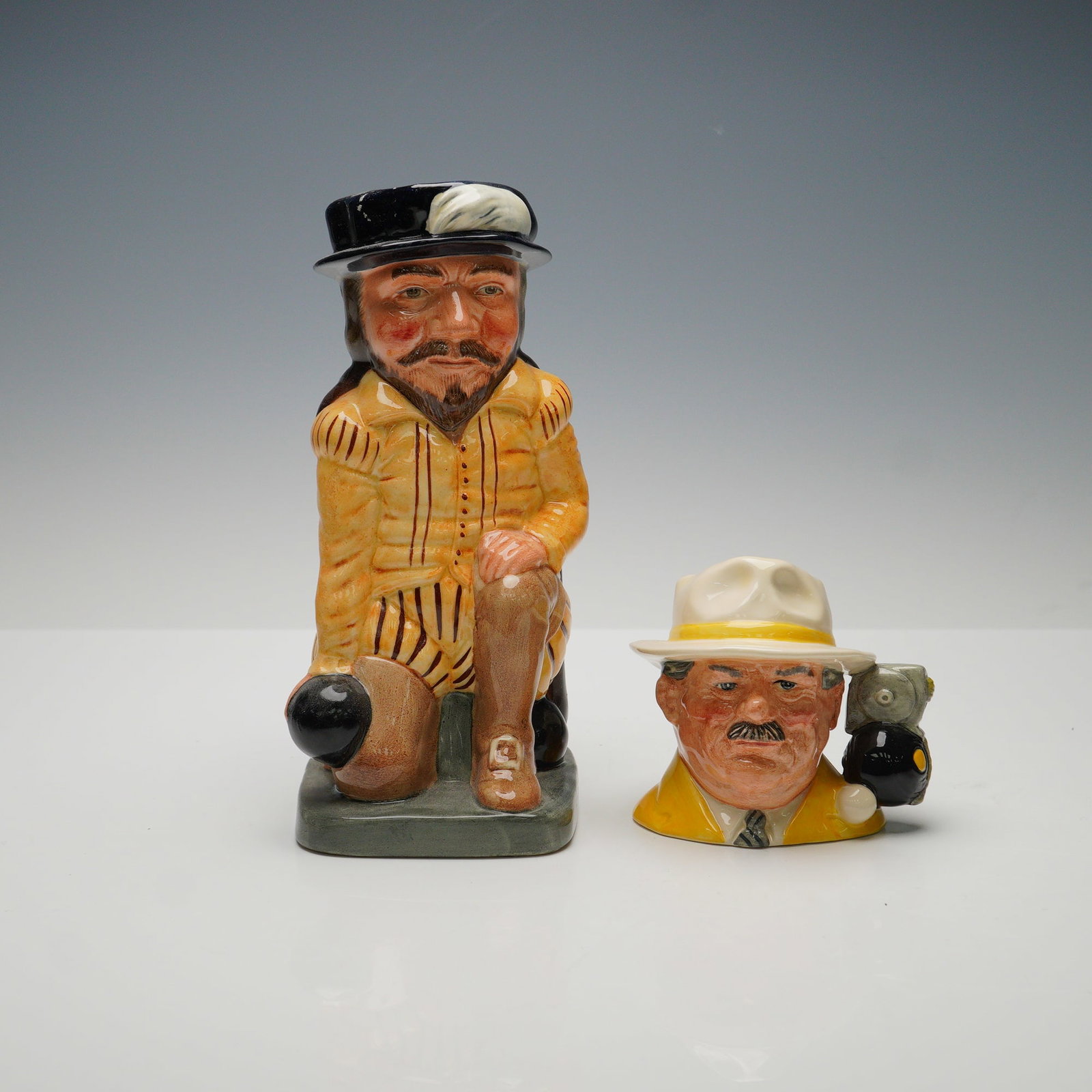 2pc Royal Doulton Jugs, Bowls Player D6896 & Sir Francis Drake D6660: This 2-piece Royal Doulton character jug set includes the Bowls Player D6896 Small character jug and Sir Francis Drake D6660 Large toby jug. Both jugs are marked with the Royal Doulton backstamp. The