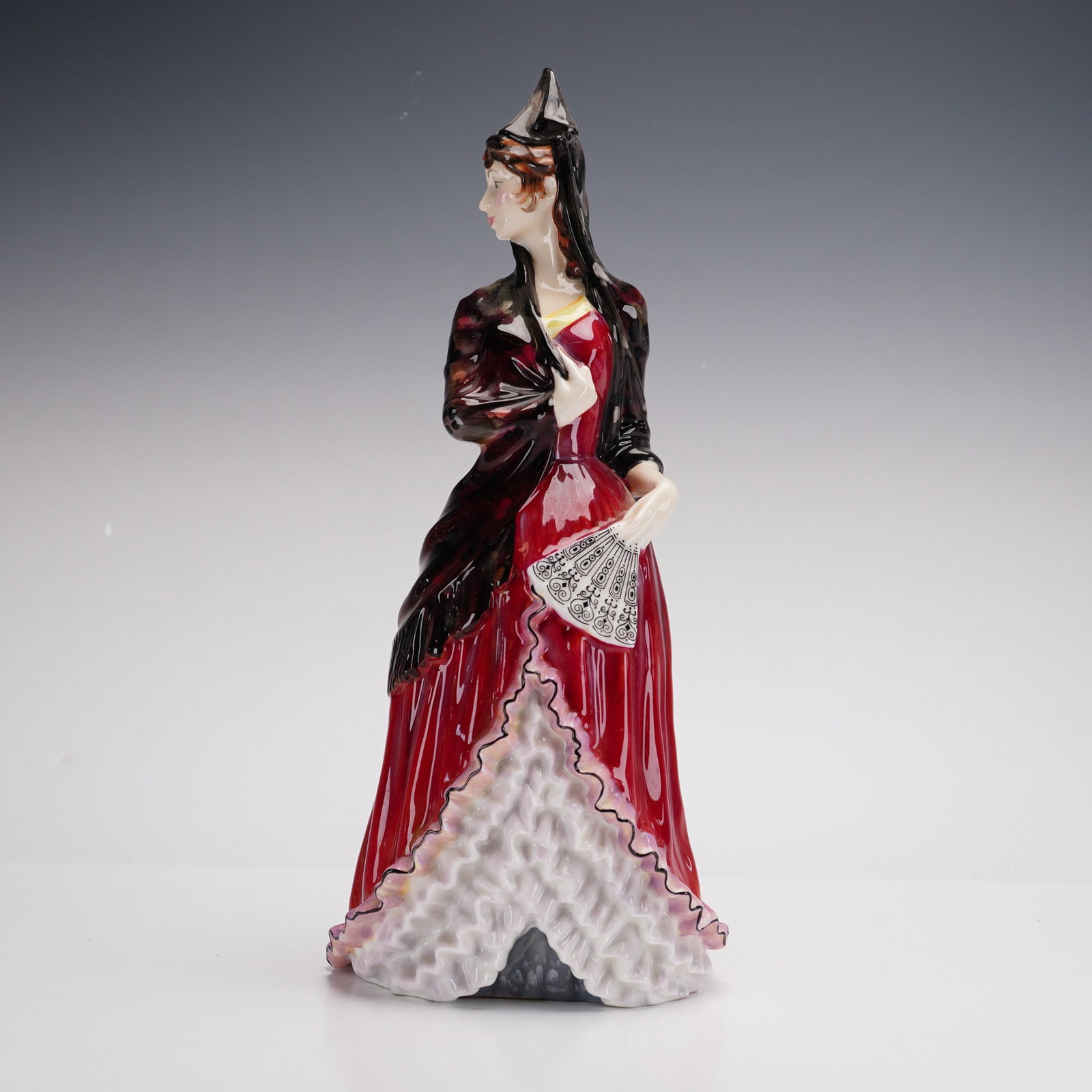 Royal Doulton, Mantilla Figurine and Inscribed Ceramic Plate: This lot features two ceramic items. The first is a Royal Doulton bone china figurine titled "Mantilla," model number HN 2712. The figure depicts a woman in a traditional Spanish-inspired red gown wit