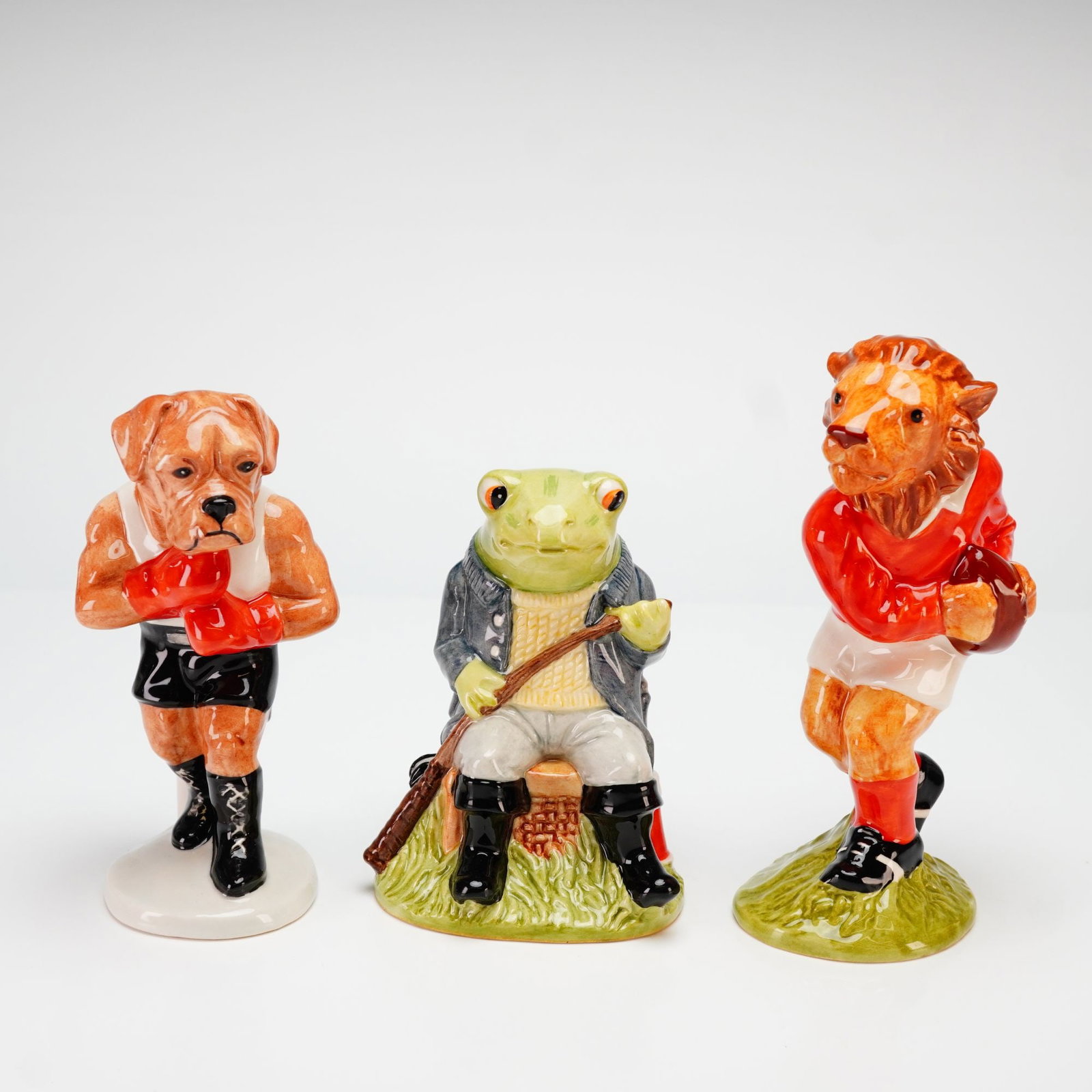 Beswick, Sporting Characters Collection Figurines: This set of three hand-painted glazed porcelain figurines is from the Sporting Characters Collection, produced by Beswick for Sinclairs in 1998. The collection features anthropomorphic animals in vari