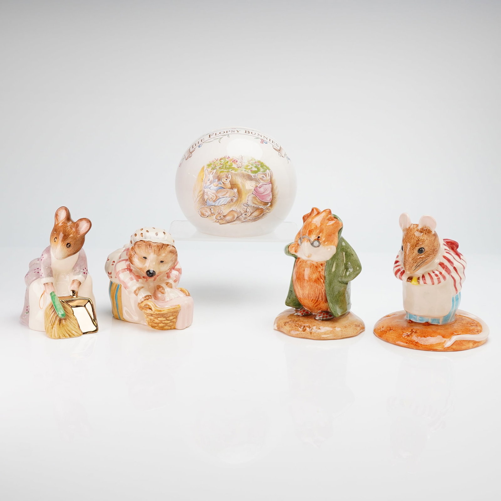5pc Beatrix Potter Set of Beswick and Royal Doulton Figurines and Bank: A 5pc Beatrix Potter set comprising four figurines by Beswick pottery works, produced under the ownership of Royal Doulton, and one bank by Royal Doulton. The hand-painted, polychrome-glazed ceramic f