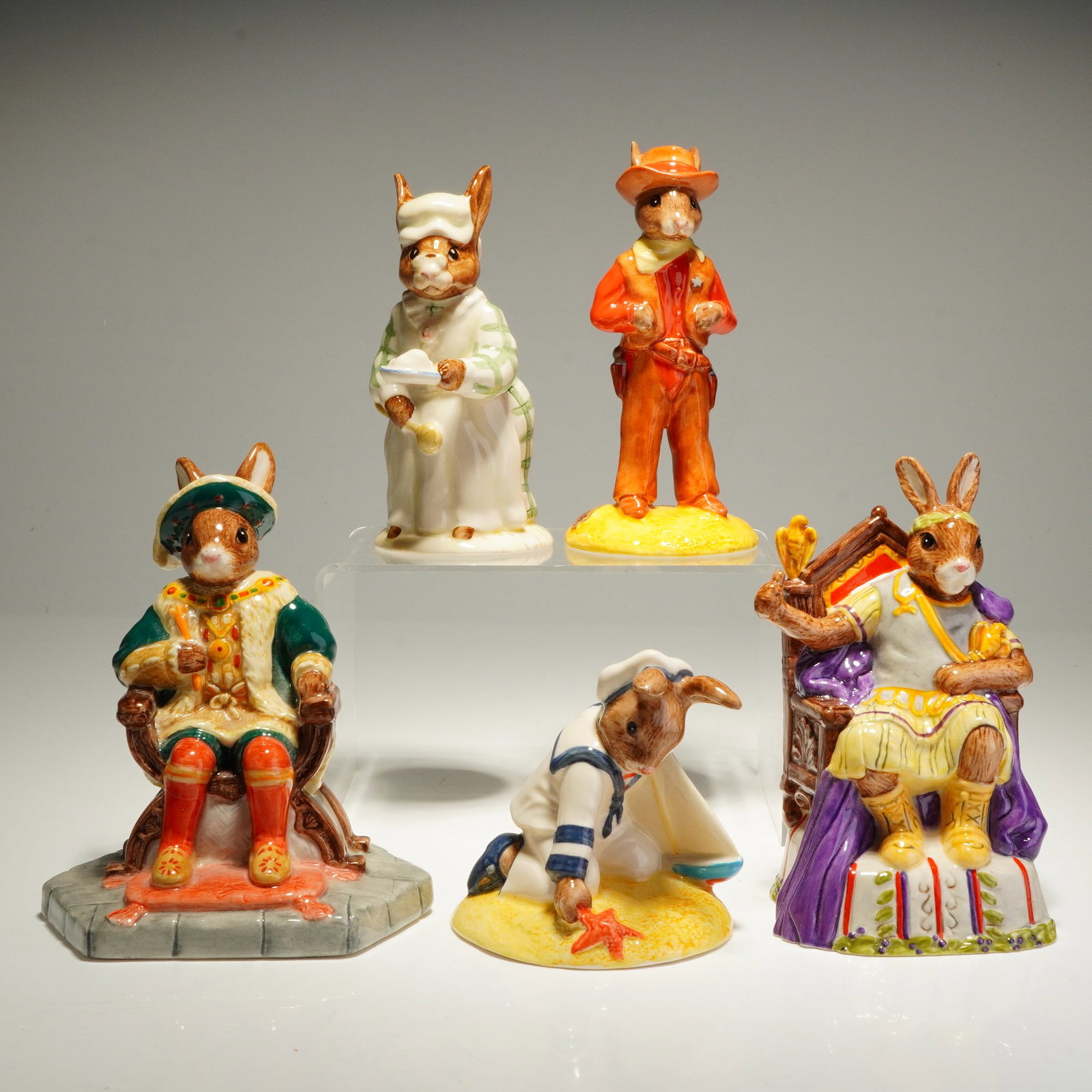 3pc Royal Doulton Bunnykins Figurines, DB166, DB312, DB201: A collection of five Royal Doulton Bunnykins porcelain figurines depicting anthropomorphic rabbits in various historical and occupational costumes. The group consists of Henry VIII from the Tudor Coll