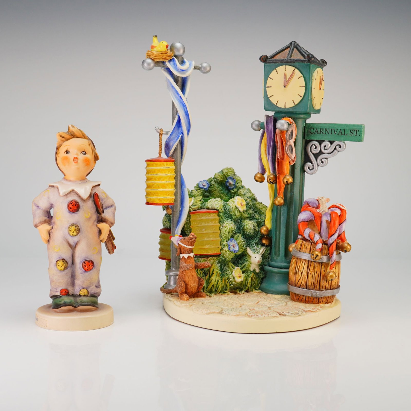 Two Goebel Hummel Items: Carnival Figurine HUM 328 and Candlelight Carnival Hummelscape 1025-D: This lot features a Goebel M.I. Hummel porcelain fig titled Carnival, model HUM 328, and a coordinating Hummelscapes Collection display base titled Candlelight Carnival. The hand-painted porcelain fig