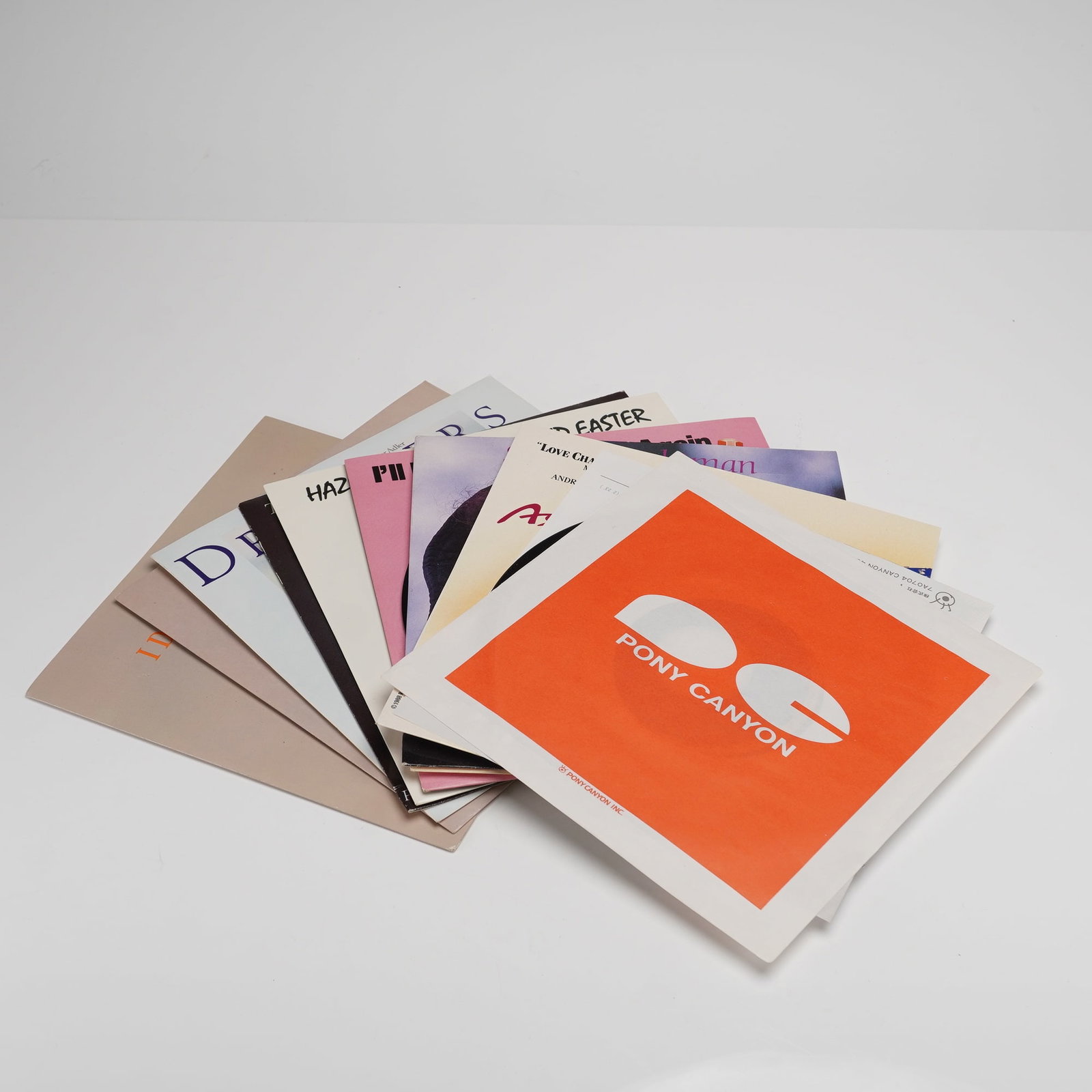 13 Record Sleeves incl. Les Miserables & Broadway Musicals: A collection of thirteen (13) individual 7-inch 45 RPM vinyl records, accompanied by a mix of original picture sleeves, generic distributor sleeves, and promotional jackets, all featuring musical and