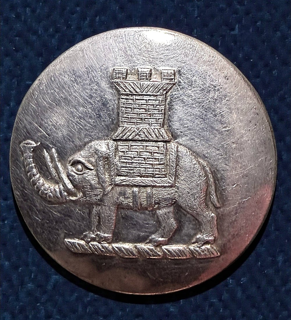 A DIVISION ONE LIVERY CREST BUTTON: 1 Medium 19th century Elephant with a Howdah example. DimensionsSM=Less than 3/4", Medium=3/4" to 1 1/4". Large=1 1/4" and above, extra large=1 3/4" and above Date or EraDIVISION 1=PRE 1918 AND DIVISI