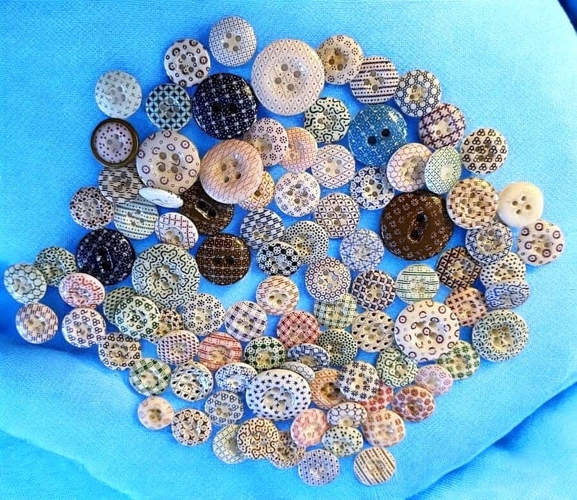A BAG LOT OF DIVISION ONE CHINA BUTTONS: A variety of late 19th/early 20th C. calico examples. DimensionsSM=Less than 3/4", Medium=3/4" to 1 1/4". Large=1 1/4" and above, extra large=1 3/4" and above Date or EraDIVISION 1=PRE 1918 AND DIVISI