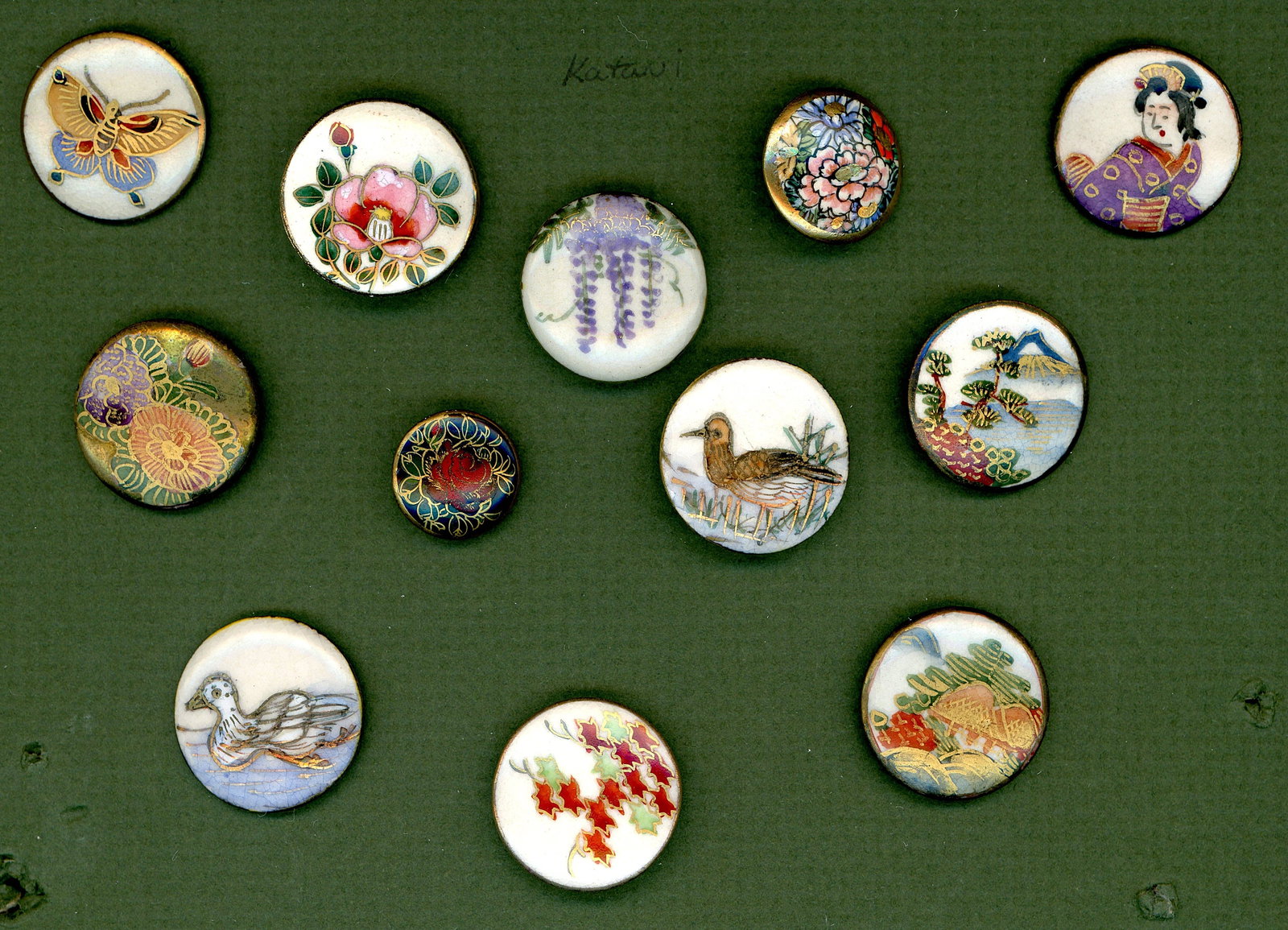 A SMALL CARD OF DIVISION THREE SATSUAM BUTTONS: 12 Small/Medium size 20th century hand painted Japanese examples. Here is a nice selection including florals, birds, butterfly, people and scenes. Very colorful and gold accented examples.