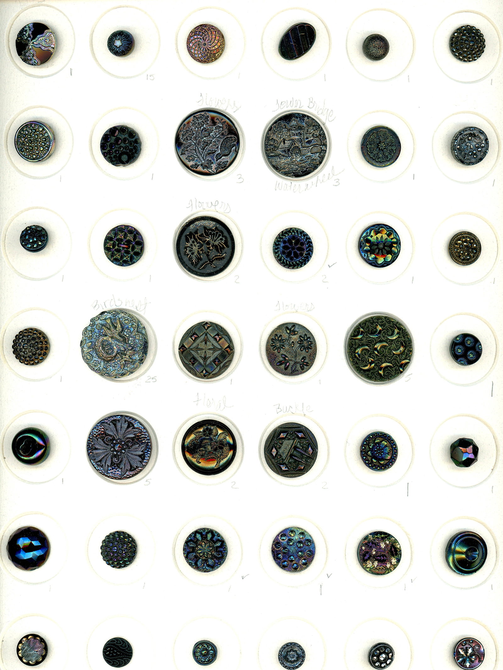 2 CARDS OF DIVISION ONE BLACK GLASS BUTTONS: 79 Small/Medium 19th century examples including Lusters. These two cards include a plethora of Iridescent lusters including patterns and pictorials. There are also other lusters included as well as a