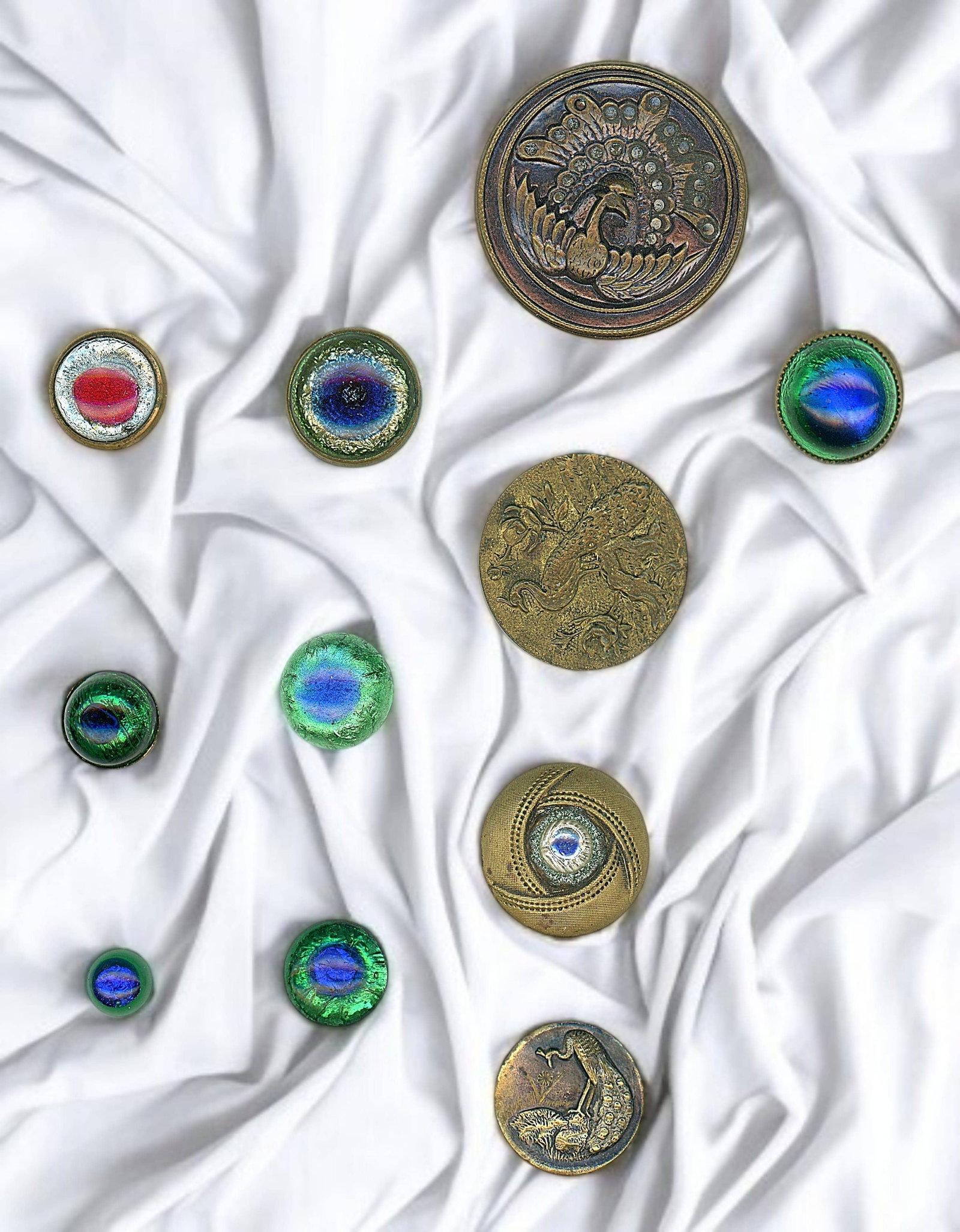 A SMALL CARD OF DIV. ONE PEACOCKS & PEACOCK EYE BUTTONS: 11 S/M/L Early 20th C. including glass in metal examples. DimensionsSM=Less than 3/4", Medium=3/4" to 1 1/4". Large=1 1/4" and above, extra large=1 3/4" and above Date or EraDIVISION 1=PRE 1918 AND