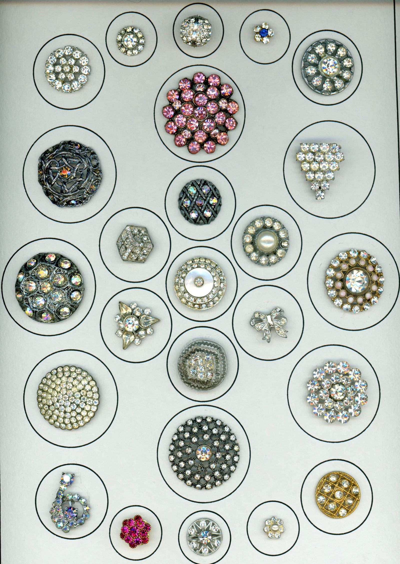 A CARD OF DIVISION THREE "GLITZ" BUTTONS: 25 S/M/L 1930's to 1950's paste jewel examples. DimensionsSM=Less than 3/4", Medium=3/4" to 1 1/4". Large=1 1/4" and above, extra large=1 3/4" and above Date or EraDIVISION 1=PRE 1918 AND DIVISION 3