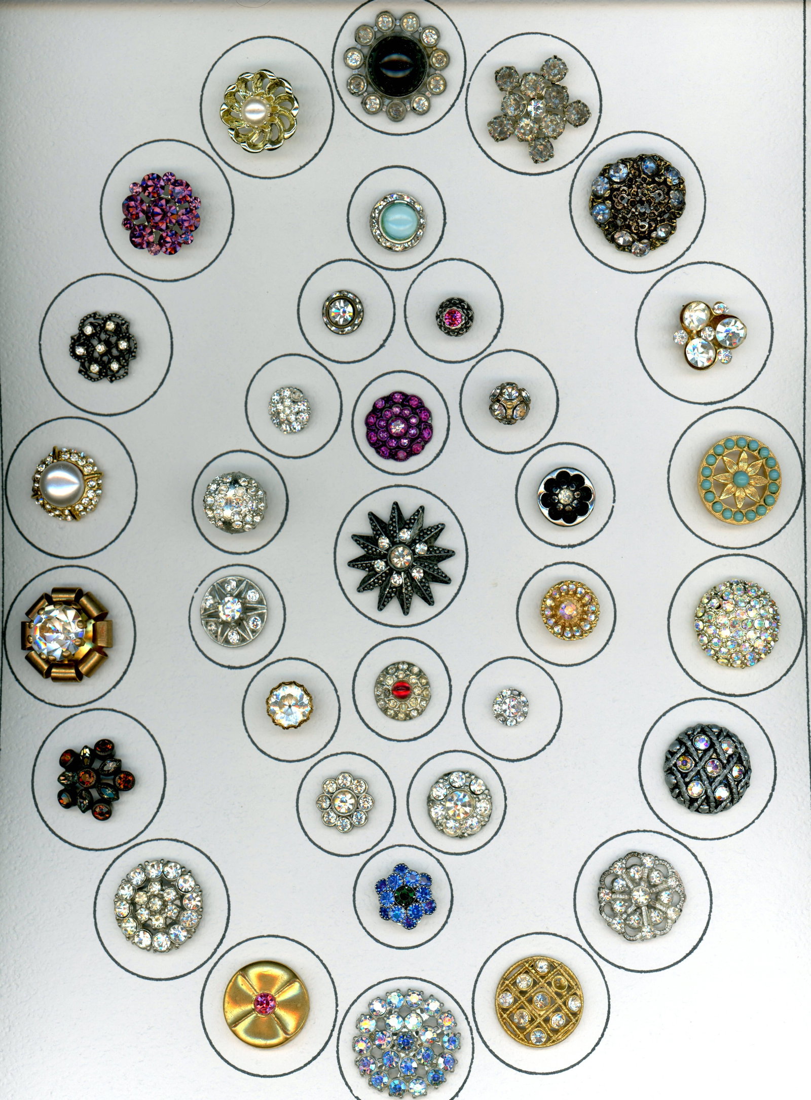 A CARD OF DIVISION THREE "GLITZ" BUTTONS: 35 S/M/L Mid 20th century colorful paste jewel examples. DimensionsSM=Less than 3/4", Medium=3/4" to 1 1/4". Large=1 1/4" and above, extra large=1 3/4" and above Date or EraDIVISION 1=PRE 1918 AND DIV