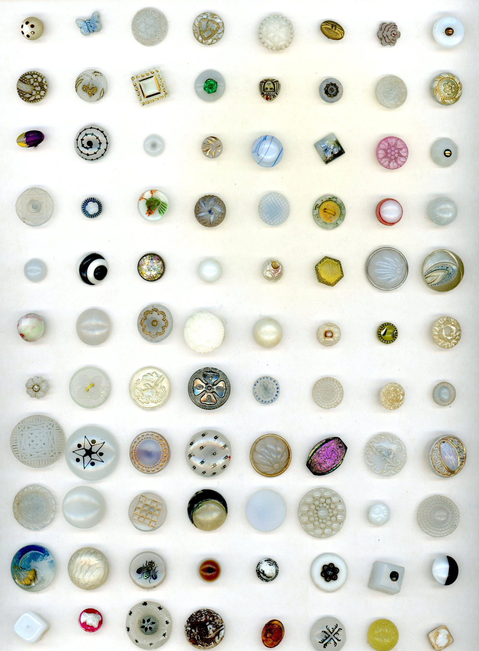 A LARGE CARD OF DIVISION ONE CHARMSTRING GLASS BUTTONS: 88 Small 19th century examples specialized to white. This card includes a plethora of techniques including Popper Glass, clambroth, pearlized, overlays, transfers, swirlbacks and more. Take a good loo
