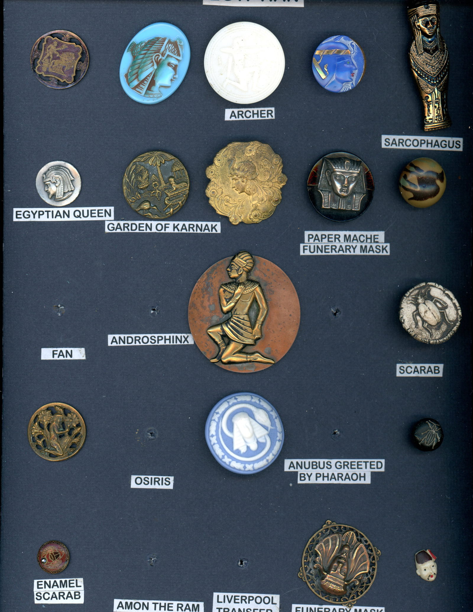 A CARD OF DIVISION 1 & 3 HEADS AND FIGURE BUTTONS: 18 S/M/L 19th/20th century assorted material Egyptian examples. DimensionsSM=Less than 3/4", Medium=3/4" to 1 1/4". Large=1 1/4" and above, extra large=1 3/4" and above Date or EraDIVISION 1=PRE