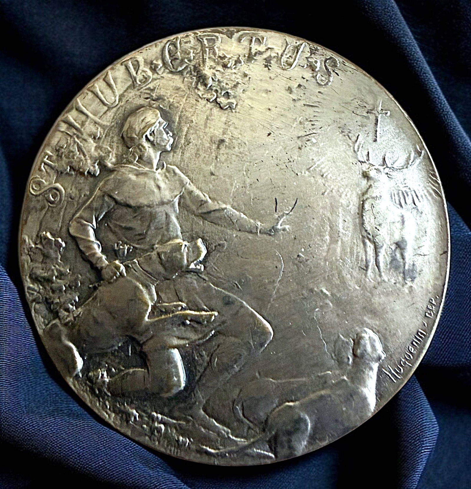 A DIVISION ONE SILVERED BRASS PICTORIAL BUTTON: 1 Large early 20th century "Huguenin" figural and verbal example. DimensionsSM=Less than 3/4", Medium=3/4" to 1 1/4". Large=1 1/4" and above, extra large=1 3/4" and above Date or EraDIVISION 1=PRE 191