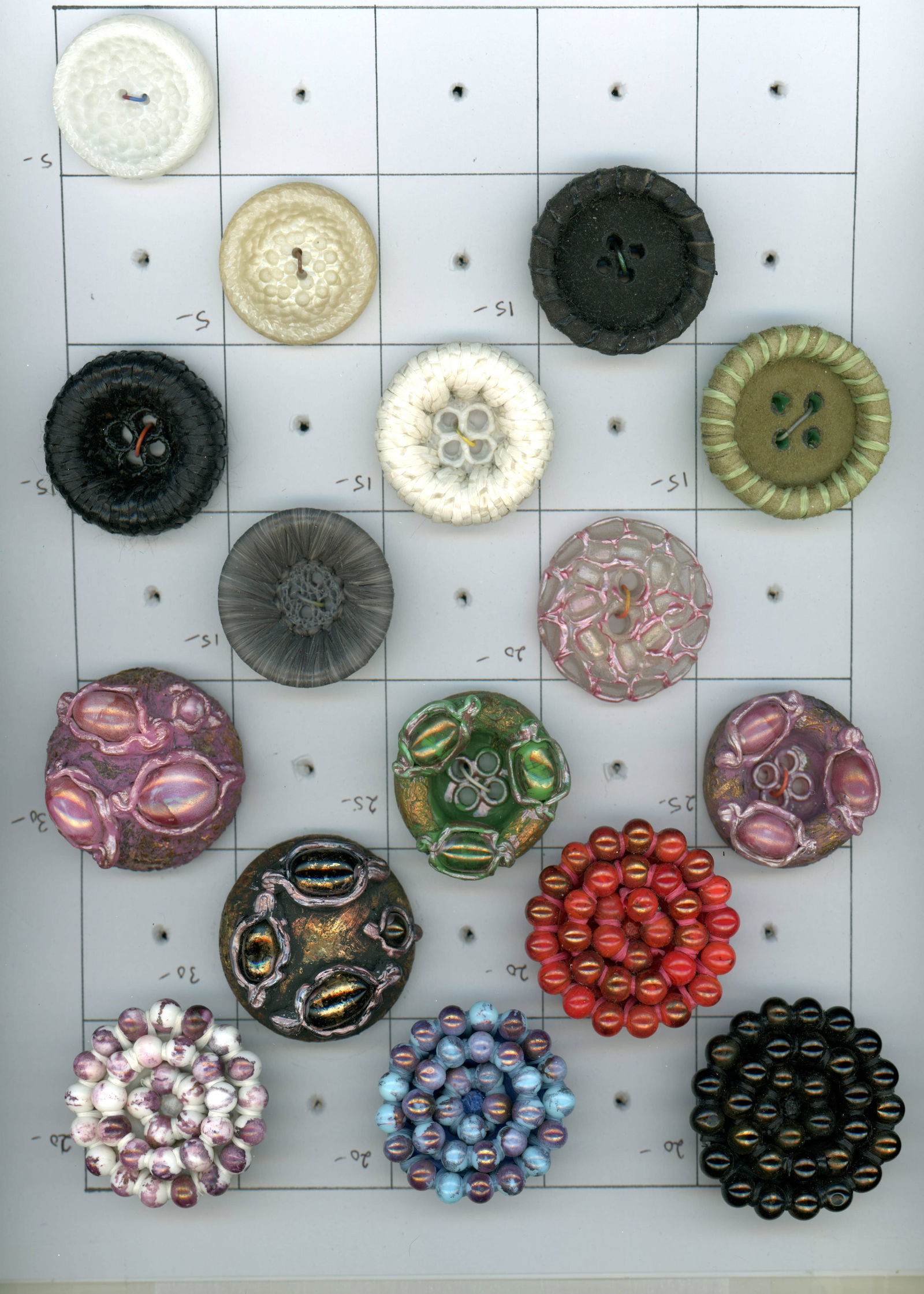 A CARD OF DIVISION THREE COUTURE STUDIO BUTTON: 16 Large 20th C. assorted crafted Couture buttons. DimensionsSM=Less than 3/4", Medium=3/4" to 1 1/4". Large=1 1/4" and above, extra large=1 3/4" and above Date or EraDIVISION 1=PRE 1918 AND