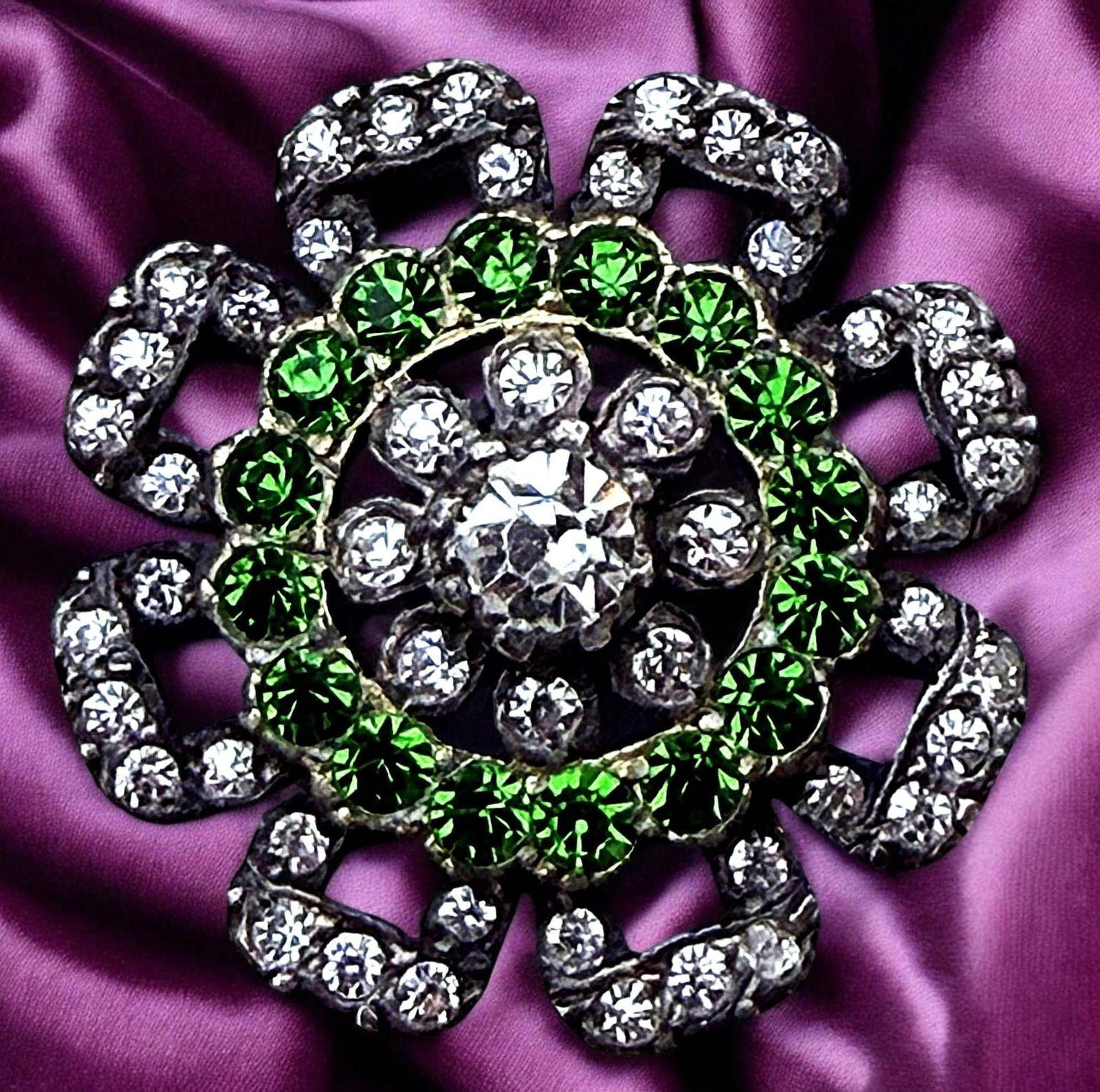A DIVISION ONE SPARKLING "GLITZ" BUTTON: A large medium 19th century silver setting green and clear jewels. DimensionsSM=Less than 3/4", Medium=3/4" to 1 1/4". Large=1 1/4" and above, extra large=1 3/4" and above Date or EraDIVISION 1=PRE 19