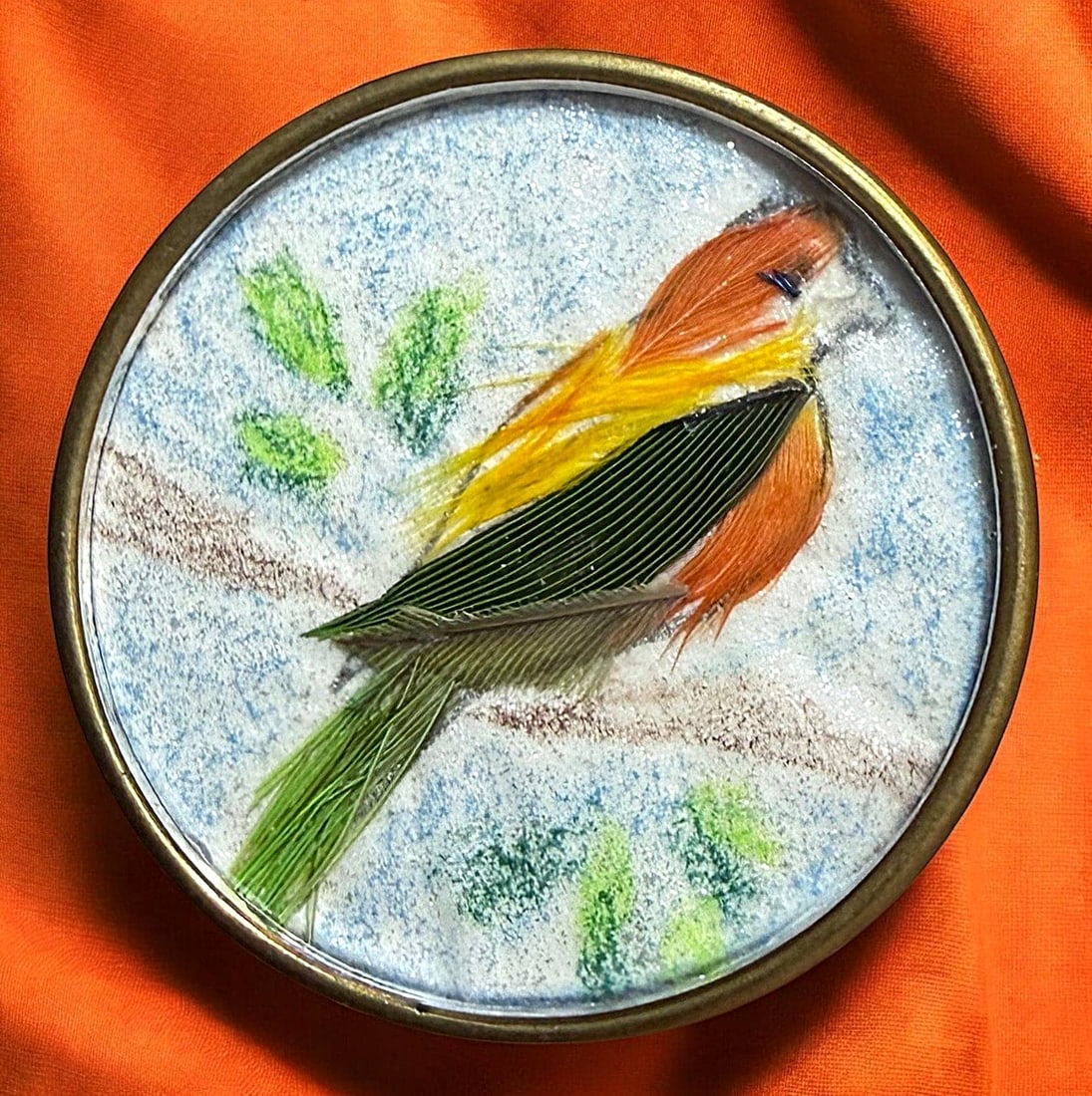 A DIVISION ONE NATURAL MATERIAL UNDER GLASS BUTTON: 1 Large early 20th C. bird of real feathers on a branch example. DimensionsSM=Less than 3/4", Medium=3/4" to 1 1/4". Large=1 1/4" and above, extra large=1 3/4" and above Date or EraDIVISION 1=PRE 1918