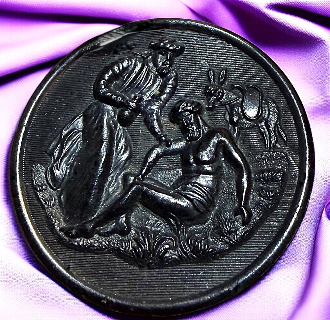 A DIVISION ONE PICTORIAL HORN BUTTON: 1 Large 19th century black dyed "Good Samaritan" example. DimensionsSM=Less than 3/4", Medium=3/4" to 1 1/4". Large=1 1/4" and above, extra large=1 3/4" and above Date or EraDIVISION 1=PRE 1918 AND