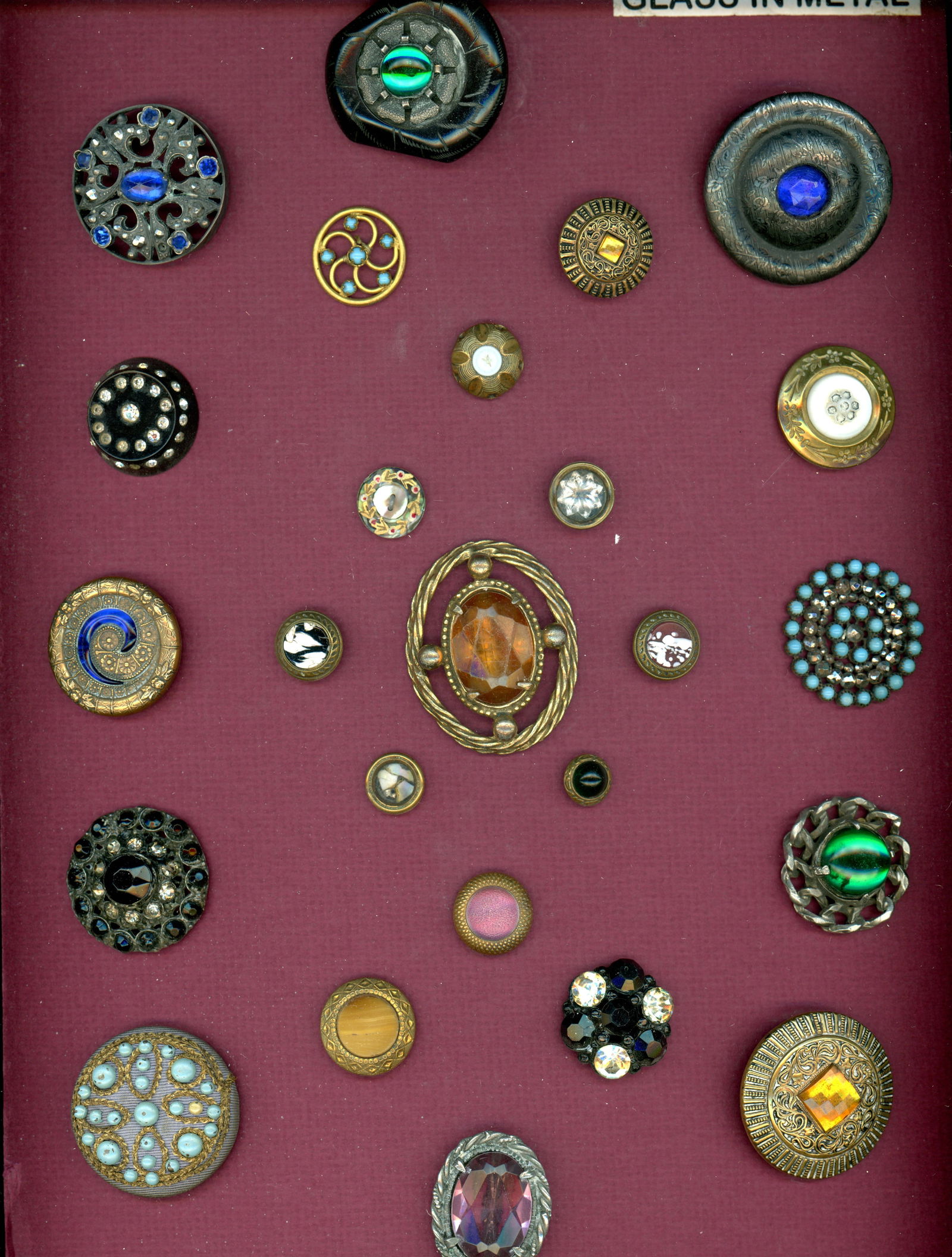 A CARD OF DIVISION 1 & 3 JEWELED BUTTONS: 25 S/M/L 19TH/20TH C. examples including glass in metal. DimensionsSM=Less than 3/4", Medium=3/4" to 1 1/4". Large=1 1/4" and above, extra large=1 3/4" and above Date or EraDIVISION 1=PRE 1918 AND DIV