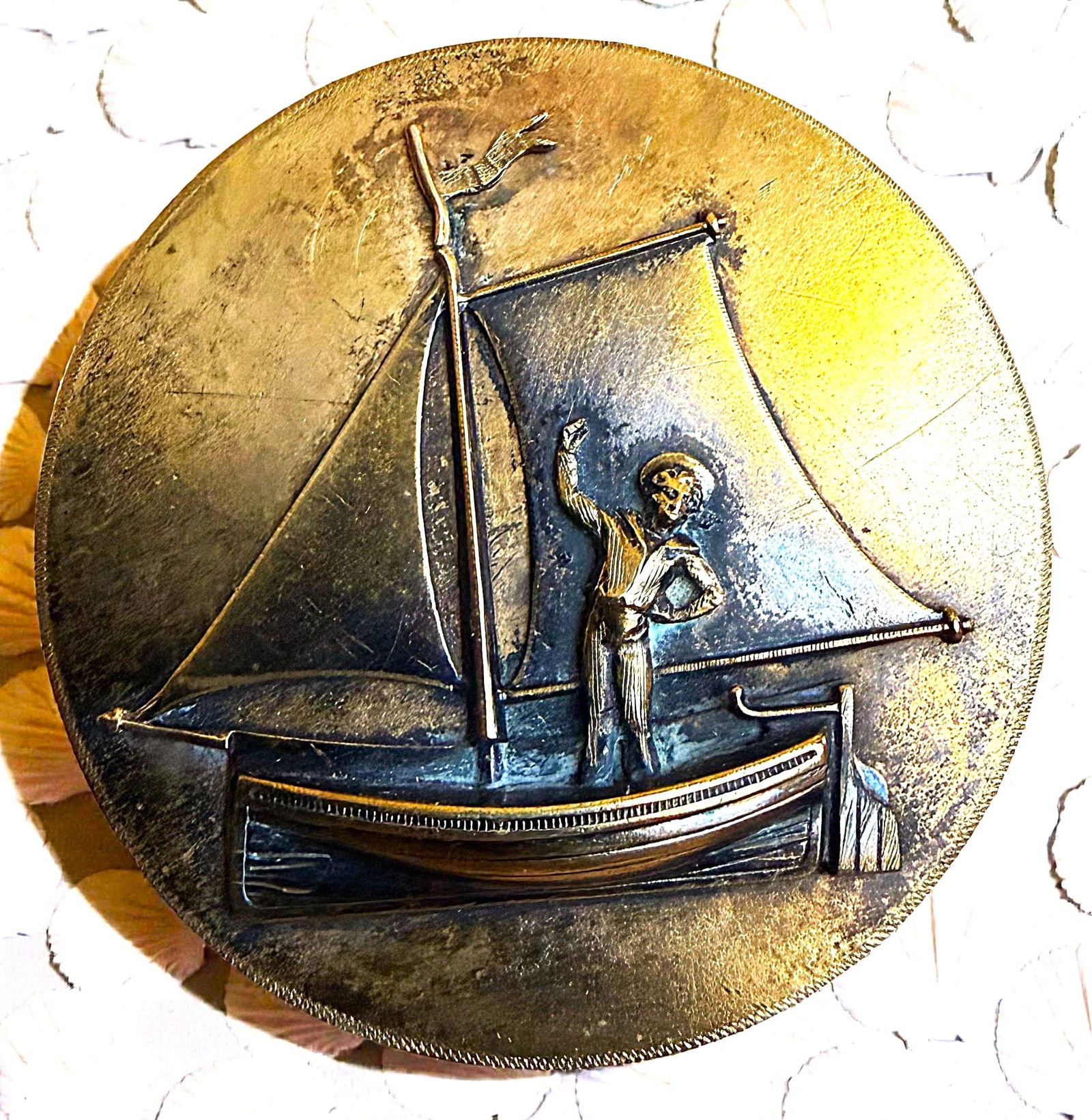 A DETAILED DIVISION ONE CHILDRENS PICTORIAL BUTTON: 1 Extra large 19th century escutcheon of a boy in a boat example. DimensionsSM=Less than 3/4", Medium=3/4" to 1 1/4". Large=1 1/4" and above, extra large=1 3/4" and above Date or EraDIVISION 1=PRE 191