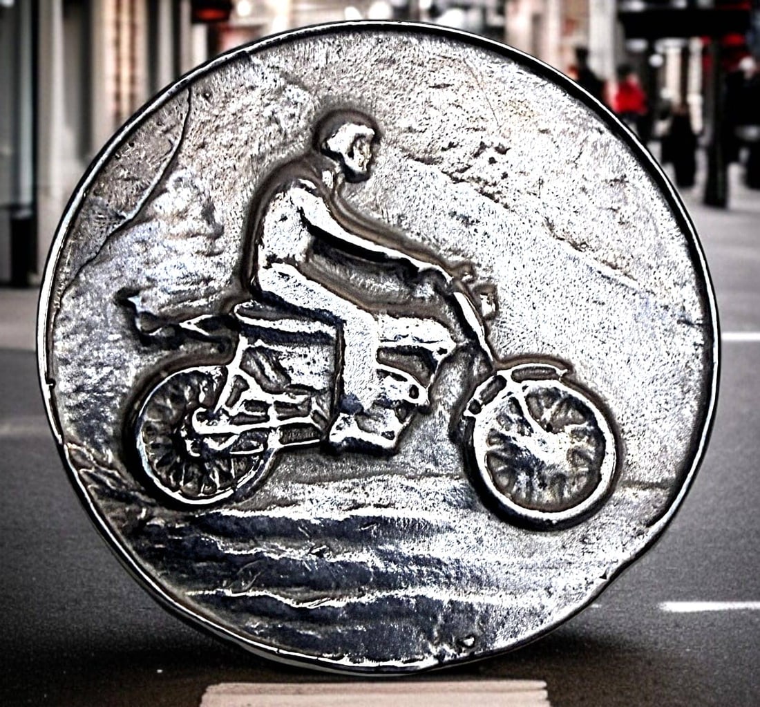 A DIVISION THREE DETAILED MOTORCYCLE BUTTON: 1 Medium size 20th century molded white metal example. Here is an incredibly detailed pewter of silver molded designed button of a rider on a motorcycle. A very cool and unusual button.