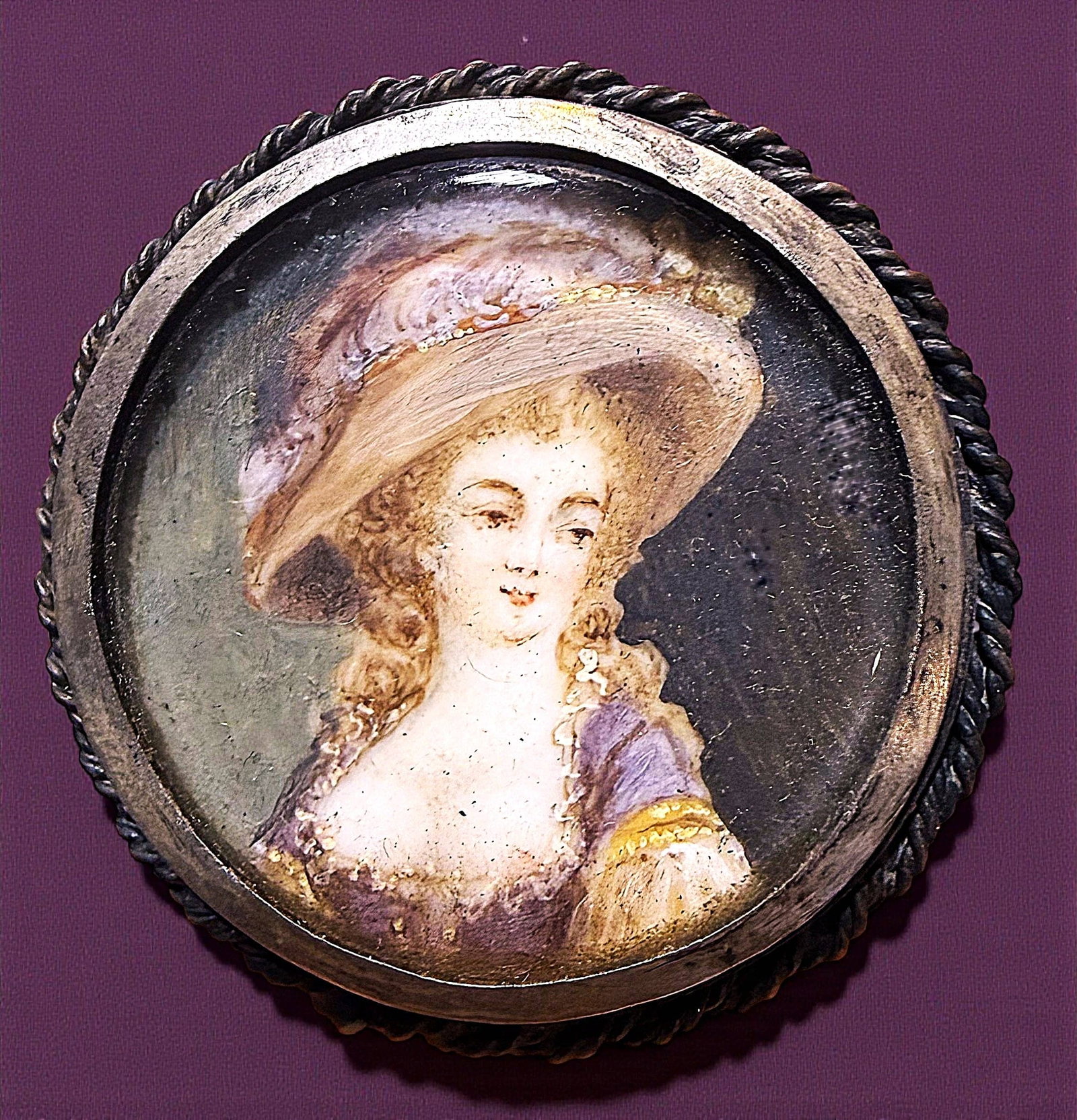 A DIVISION ONE HAND PAINTING UNDER GLASS BUTTON: 1 Large medium 19th century painting on natural material example. Just look at the expression on this young women's face, I wonder what she was thinking at the time of this rendition. The colors and f