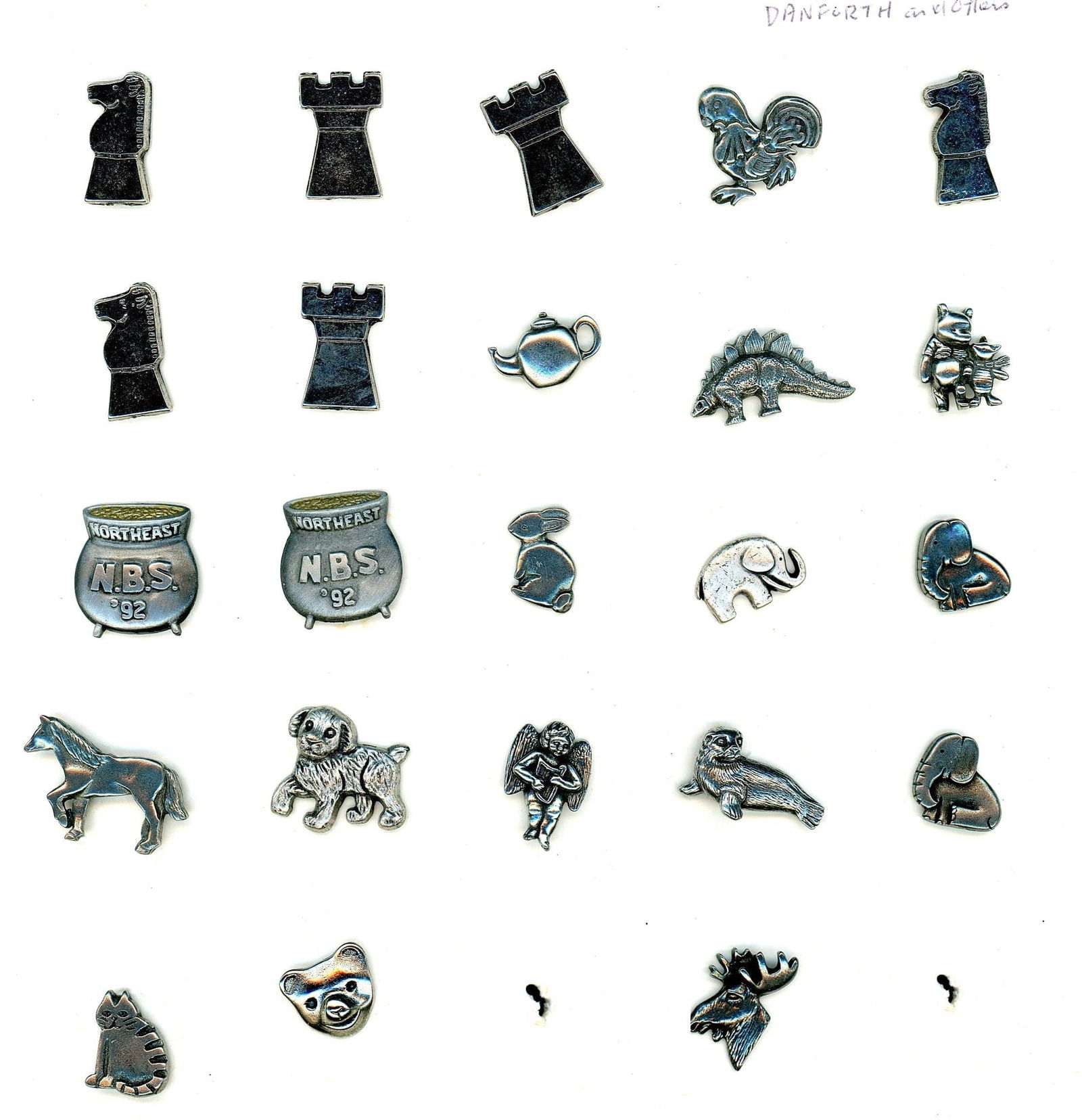 A PARTIAL CARD OF DIVISIO0N THREE PEWTER BUTTONS: 23 Medium 20th century Danforth Pewter company examples. DimensionsSM=Less than 3/4", Medium=3/4" to 1 1/4". Large=1 1/4" and above, extra large=1 3/4" and above Date or EraDIVISION 1=PRE 1918 AND DIV