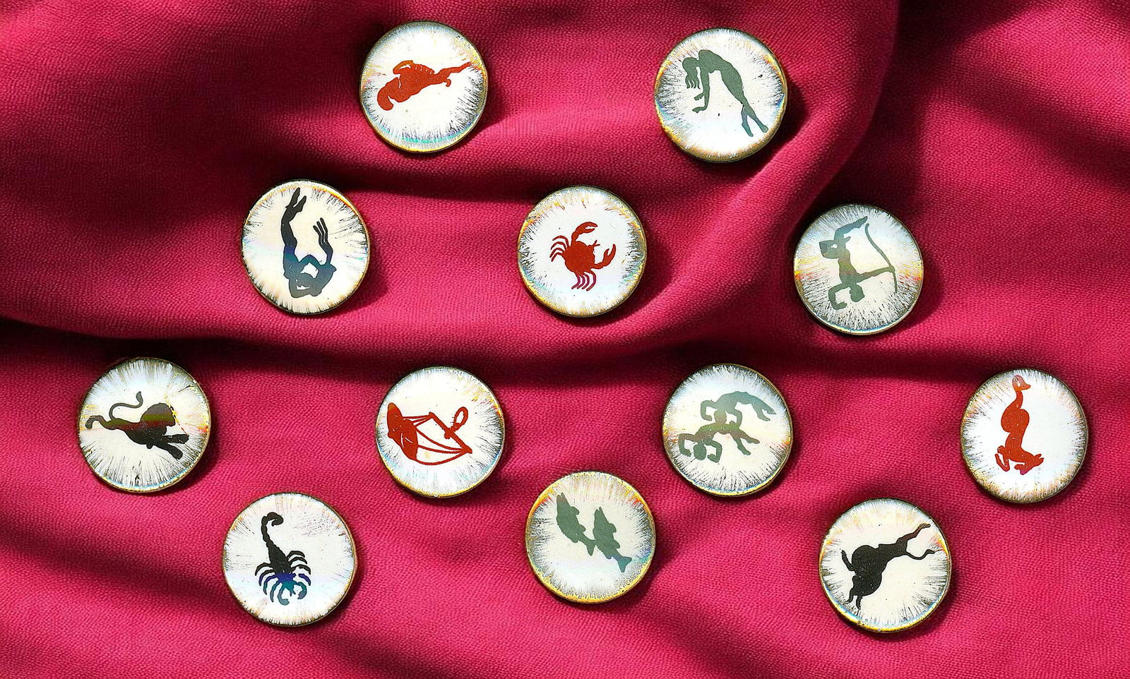 A SET OF DIVISION THREE PORCELAIN BUTTONS: 12 Medium size 20th century signs of the zodiac examples. DimensionsSM=Less than 3/4", Medium=3/4" to 1 1/4". Large=1 1/4" and above, extra large=1 3/4" and above Date or EraDIVISION 1=PRE 1918 AND DI