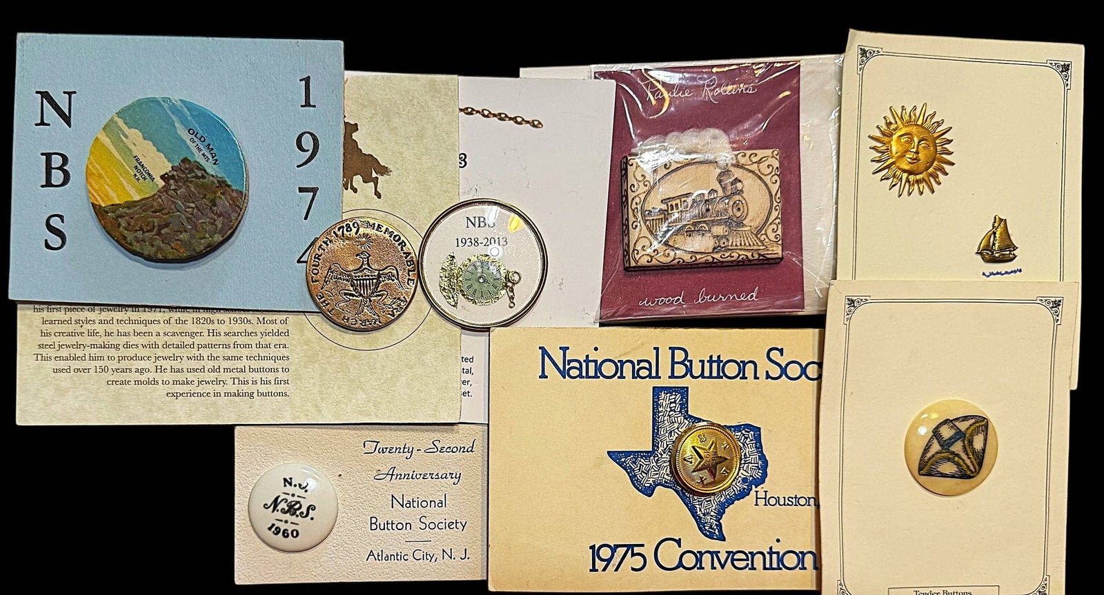 A SELECTION OF DIVISION THREE NBS FAVOR BUTTONS: 9 Medium/Large 20th/21st century assorted examples. This nice selection includes George Washington Inaugural repro example, a great wood burned train example, and others all on the original cards. In