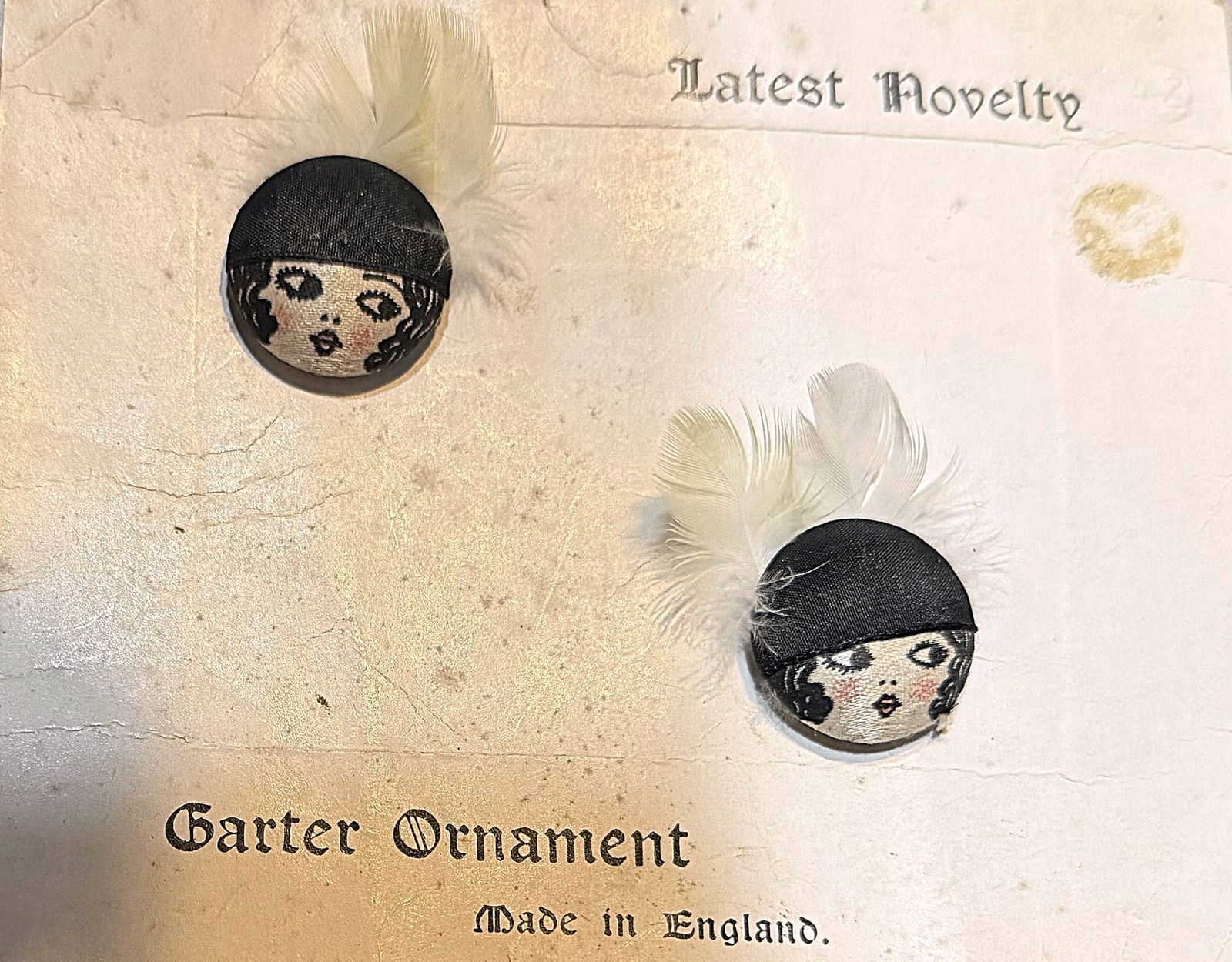 A SMALL CARD OF DIVISION THREE FABRIC BUTTONS: 2 Medium size 1920's pictorial "Flapper" buttons. These old examples are very desirable among collectors and this pair are especially appealing mounted on this original card from England and accented