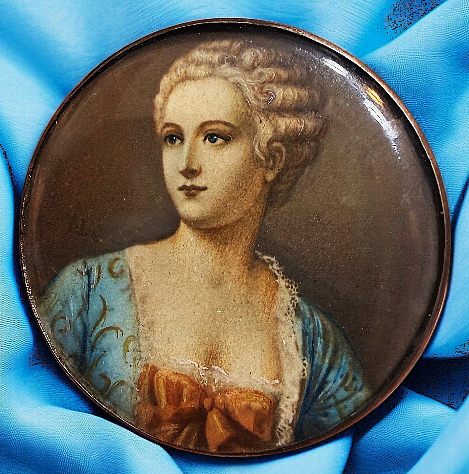 A DIVISION ONE HAND PAINTING UNDER GLASS BUTTON: 1 Large 19th C. beautifully executed female bust under glass. This example of artistry from the late 19th century is so vibrantly colored and so detailed in the design it was obviously painted by a ve