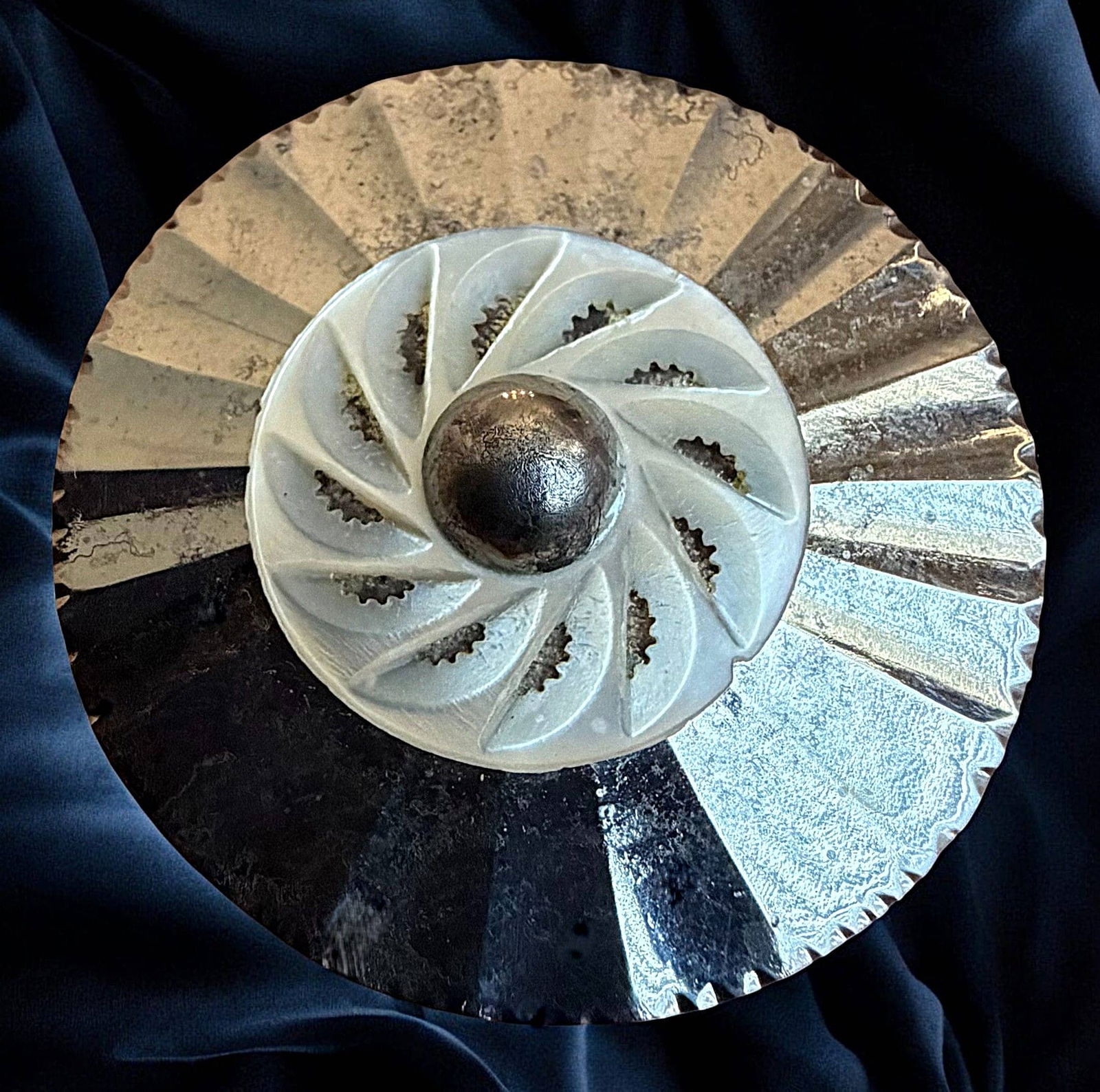 A DIVISION ONE PATTERNED STEEL BUTTON: 1 Large 18th century fluted steel and pearl example. Here is a very nice example of the 18th century showing a fluted steel base with a pinshanked attached carved and pierced pearl center. DimensionsS