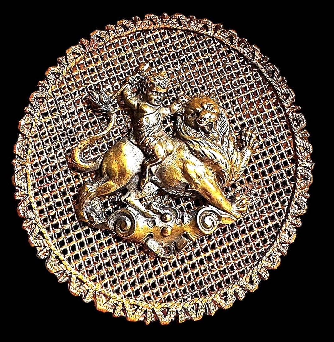 A DIVISION PIERCED PICTORIAL BUTTON: 1 Extra large 19th century SCREENBACK cherub example. This is a finely made and fine detailed pierced openwork button known to collectors as a screen back. This particular example has a cherub riding