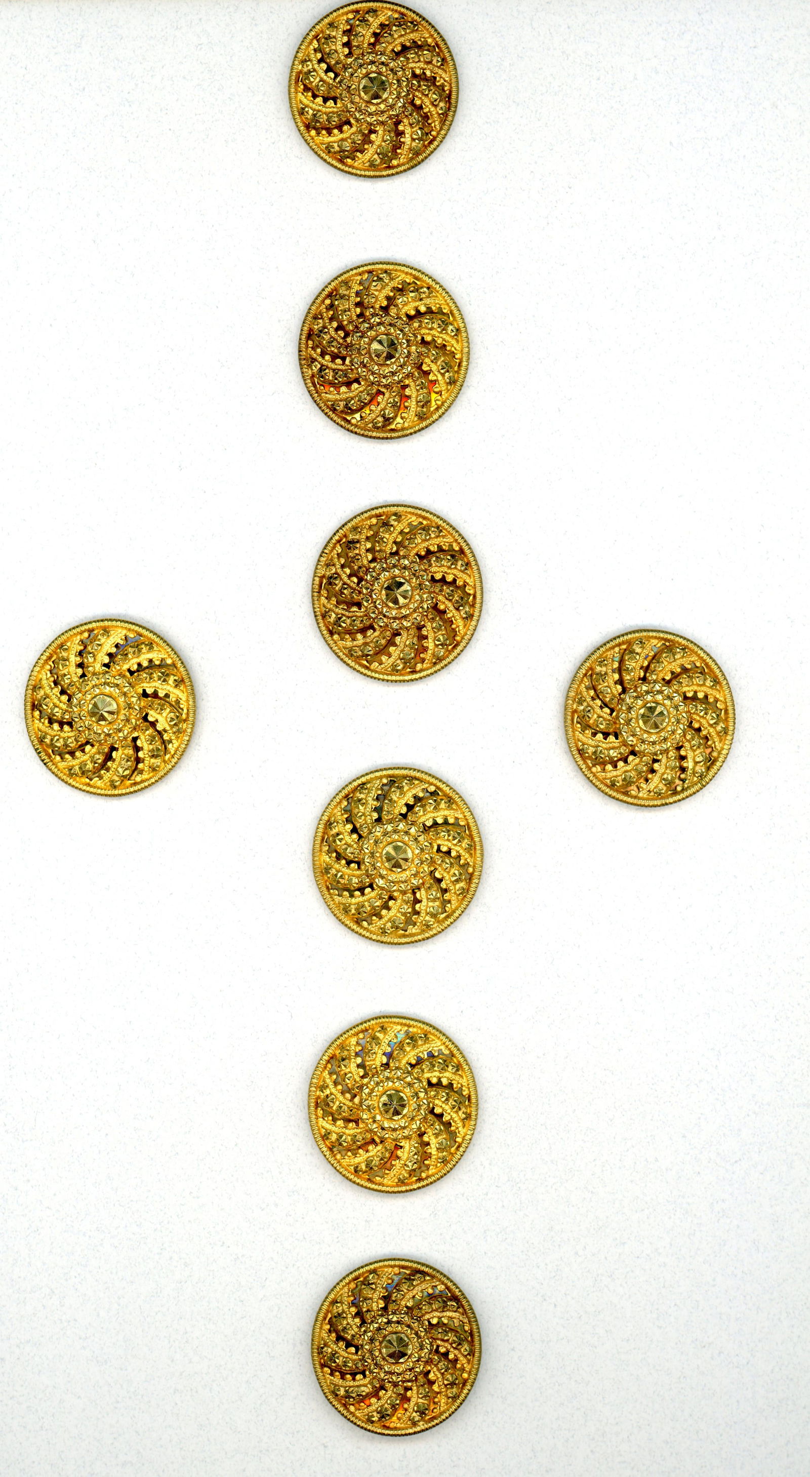 A CARD OF DIVISION THREE GILDED METAL BUTTONS: 8 Large early 20th century Faux paste jeweled buttons. These striking sparkling buttons are fooler, they appear at first glance to be claw set paste jewels but upon close examination they are a gilded