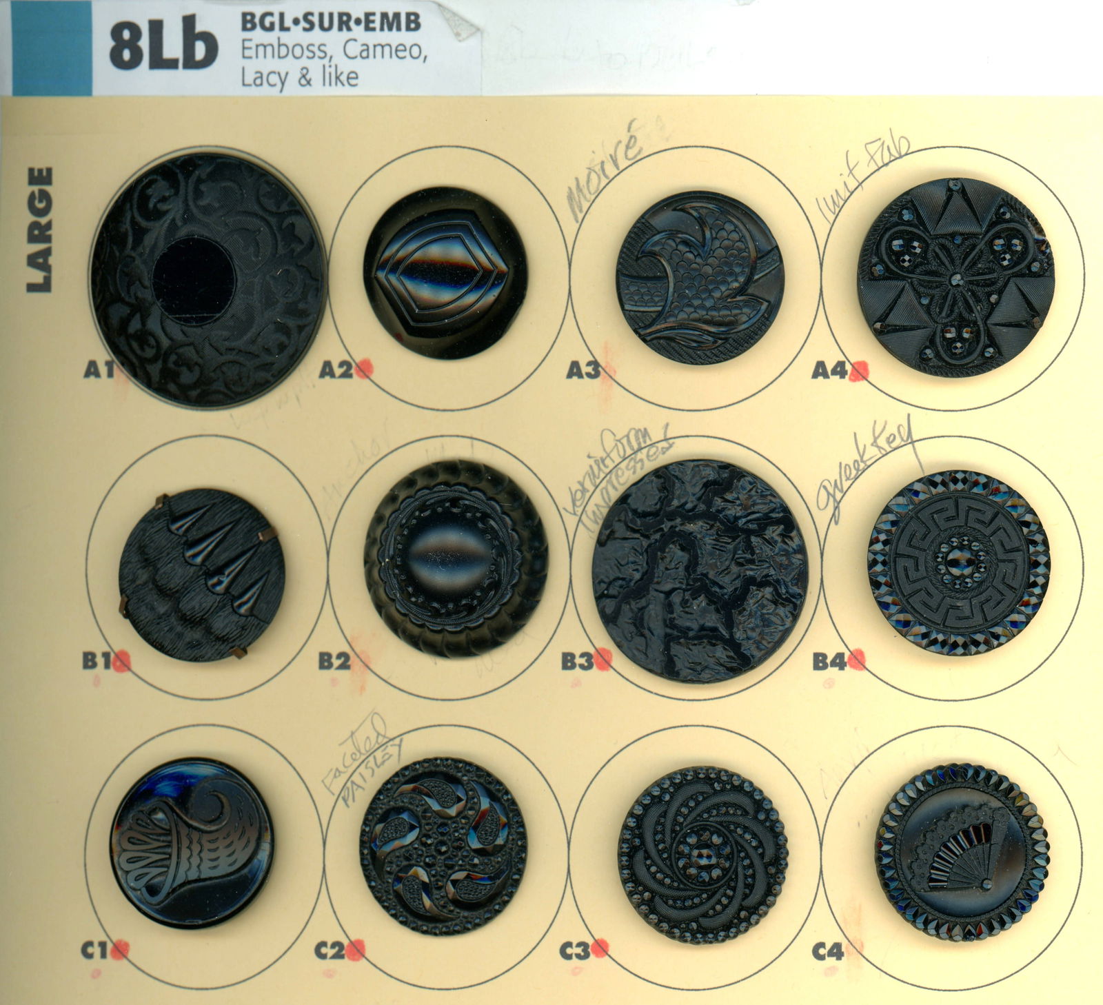 A PARTIAL CARD OF DIVISION ONE BLACK GLASS BUTTONS: 12 Large 19th century examples including pictorial. This card of Nikki Deals includes a beautiful lacy style fan, a great cornucopia, and several other nice examples. DimensionsSM=Less than 3/4", Medi