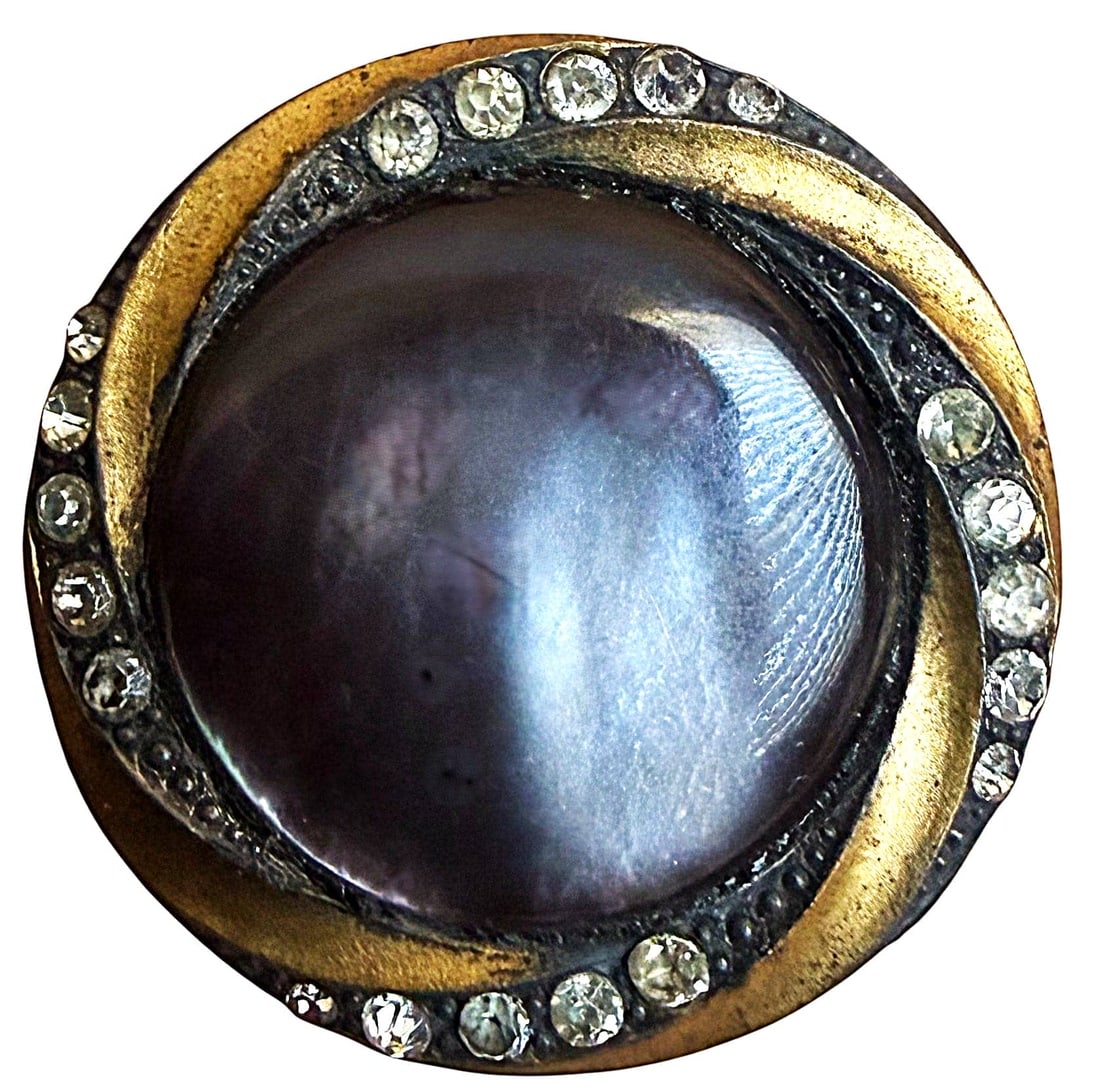 A DIVISION ONE TWO TONE BRASS AND PASTE JEWEL BUTTON: 1 Large-Medium 1 1/4" 19th C. shell mounted in metal example. This is a stunning button with the silvered and gilded brass border with inset brilliant pastes surrounding the smokey chatoyant pearl cen