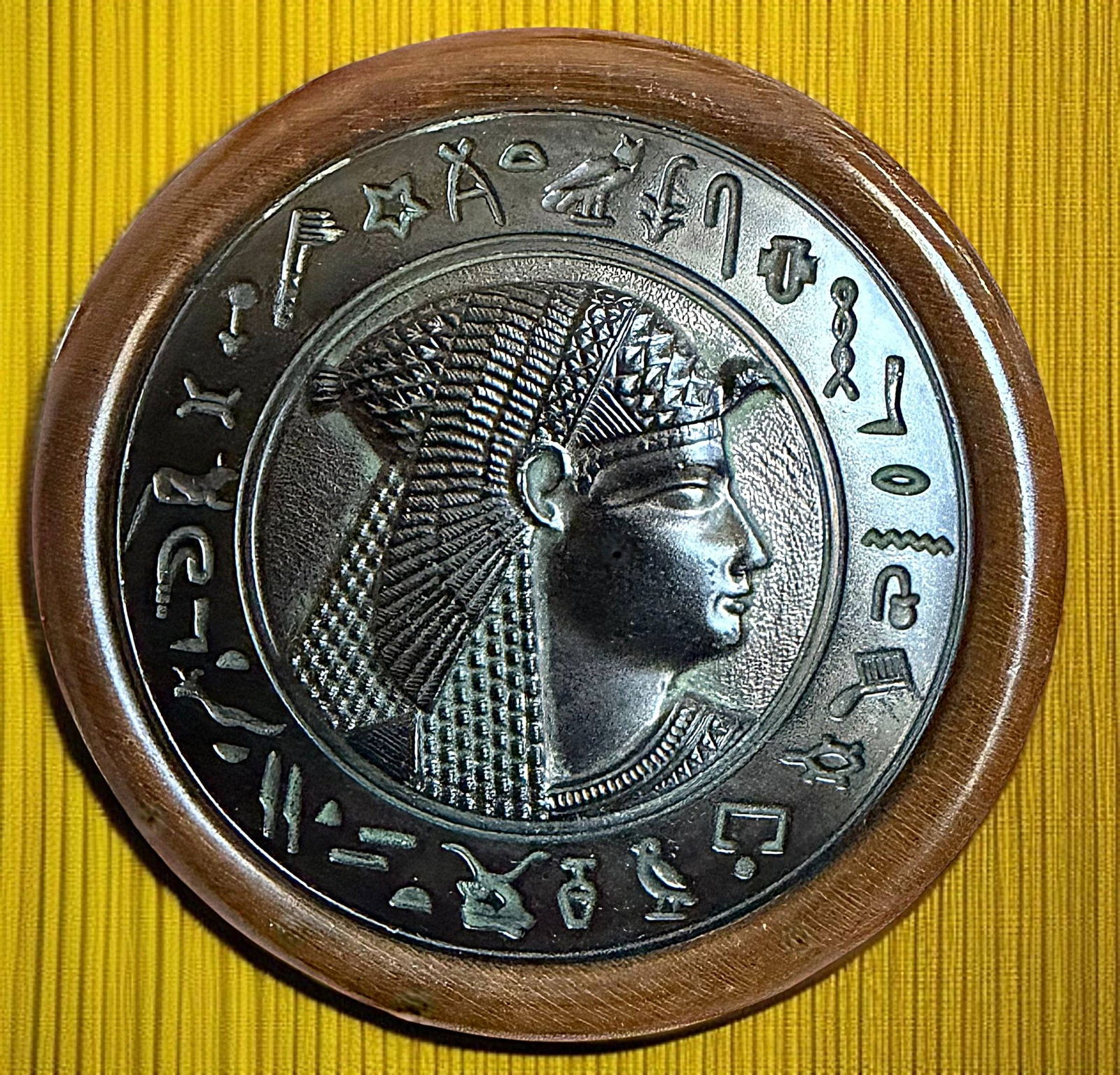 A DIVISION ONE EGYPTIAN THEMED BUTTON: 1 Extra Large size 19th century wood and metal engraved example. I have always loved this button. The extra large wood base is carved out to allow for the metal engraved original tint Egyptian motif t