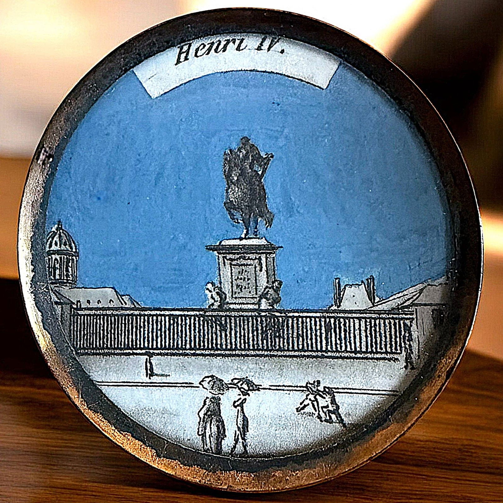A DIV. 1 IDENTIFIABLE ARCHITECTURAL STRUCTURE BUTTON: 1 Large 18th C. under glass of the statue of Henri IV. This steel engraved paper under glass with a sky blue background depicts the famous statue of Henri IV set on the bridge Pont Neuf in Paris Franc