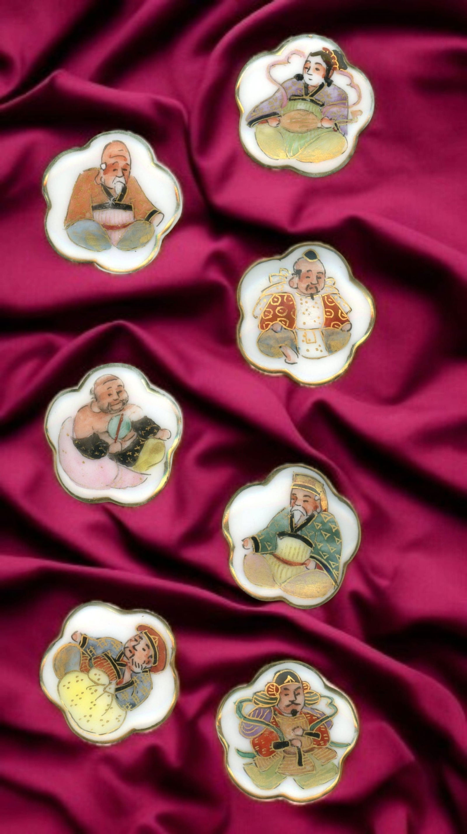 A SMALL CARD OF DIVISION 3 SCARCE CERAMIC BUTTONS: 7 Medium 1930's scalloped Kutani porcelain examples. This set of 7 Japanese Immortal gods is not your typical set collectors often find. This set from the Kutani province and known to collectors as Ku