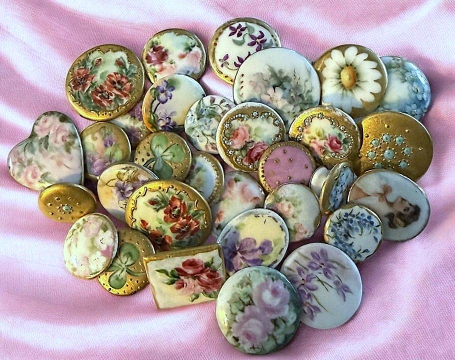 A BAG LOT OF DIVISION 1 HAND PAINTED PORCELAIN BUTTONS: This large selection of early 20th century are stud examples. This is a beautiful selection of various shapes including a great heart example, and various floral designs in a beautiful array of colors
