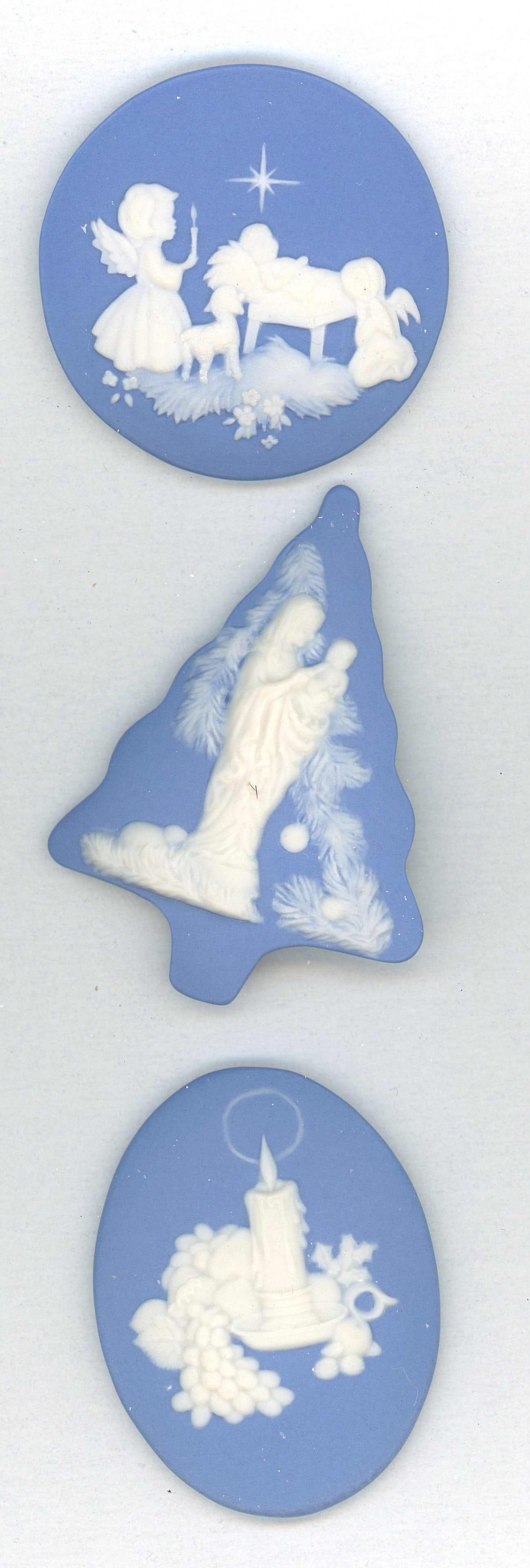 A SMALL CARD OF DIVISION THREE STUDIO ARTIST BUTTONS: 3 EX-Large 20th century blue Jasperware examples by Rzanski. The buttons on this small card are all dated 2004 and depict various Christmas scenes. Some nice shapes too. DimensionsSM=Less than 3/4", M