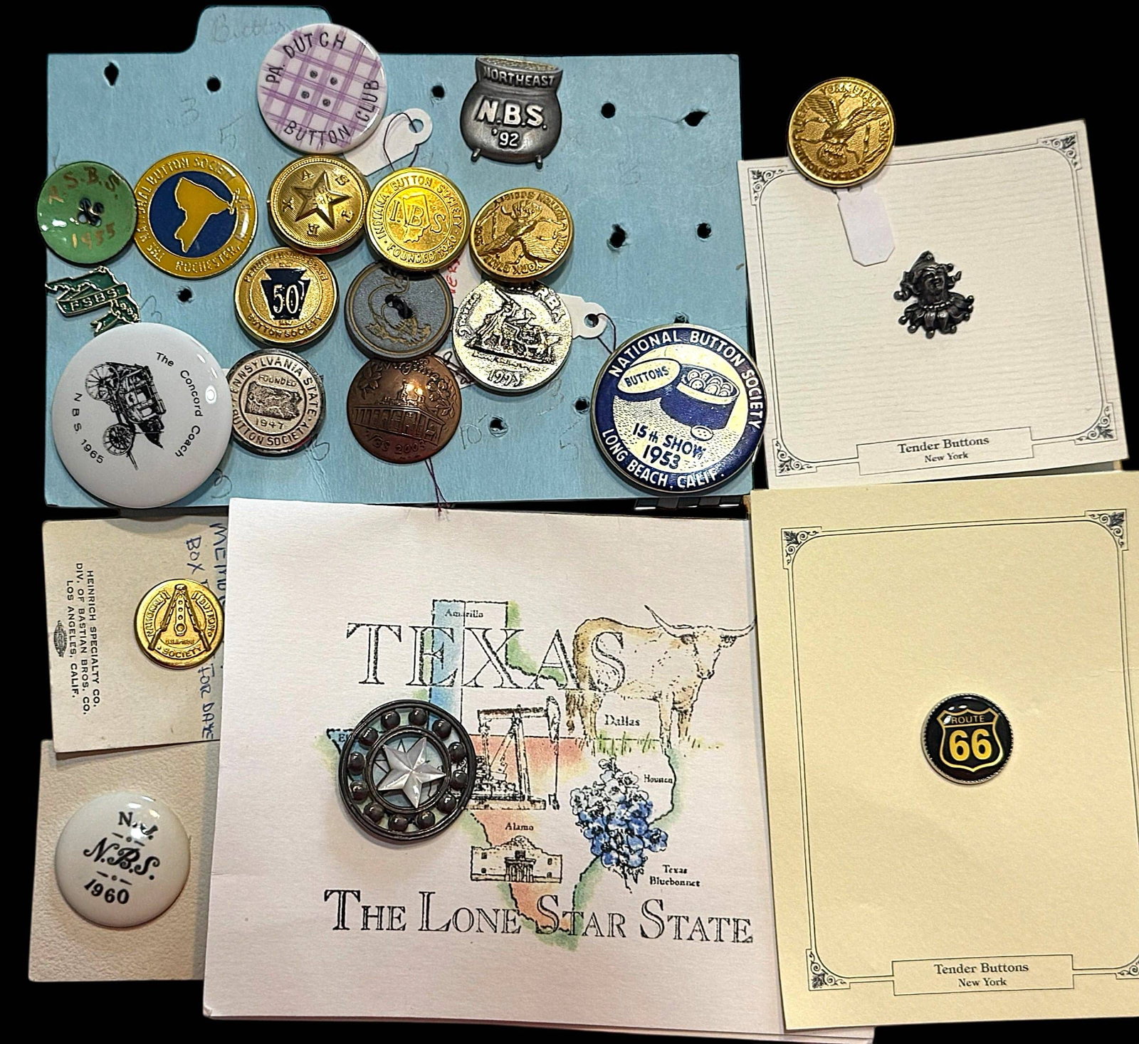 A SELECTION OF DIVISION THREE NBS FAVOR BUTTONS: 21 Medium/Large 20th/21st century assorted examples. This nice selection includes a wonderful pearl star in silver from the 2007 Texas convention, a pot of gold in pewter from the 1992 Manchester New
