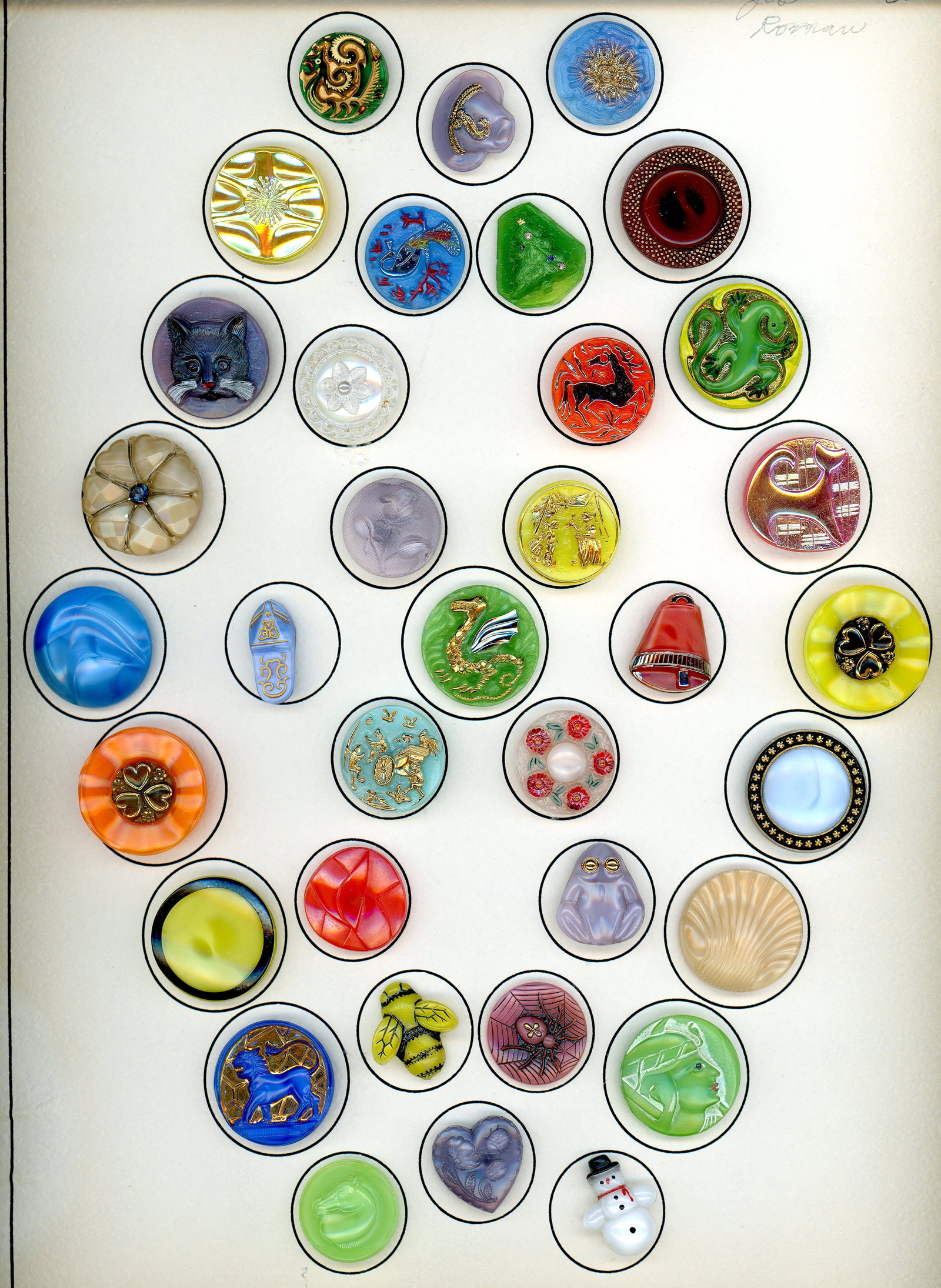 A CARD OF COLORFUL DIVISION THREE MOONGLOW BUTTONS: 35 Medium 20th century examples including pictorials. Look very close as there are several very nice examples including pictorial on this card of luscious colored glass buttons like candy, all ready t