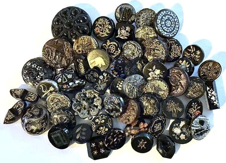 A NICE BAG LOT OF DIVISION ONE BLACK GLASS BUTTONS: An assortement of 19th century examples in various techniques. This bag lot full of assorted black glass includes lusters, incised, shapes, pictorials, patterns and more. DimensionsSM=Less than