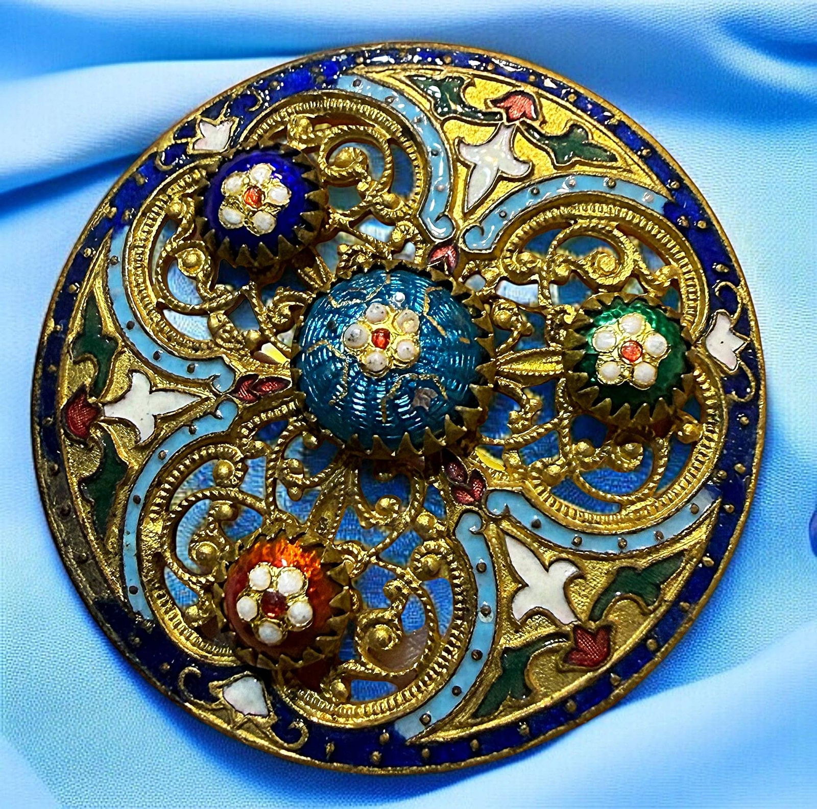 A DIVISION ONE MULTI TECHNIQUE ENAMEL BUTTON: 1 Large 19th century very colorful plaquette example. This multi technique enamel button is not a common example to find. The base is gilded pierced brass with an all over Champleve enamel design upon