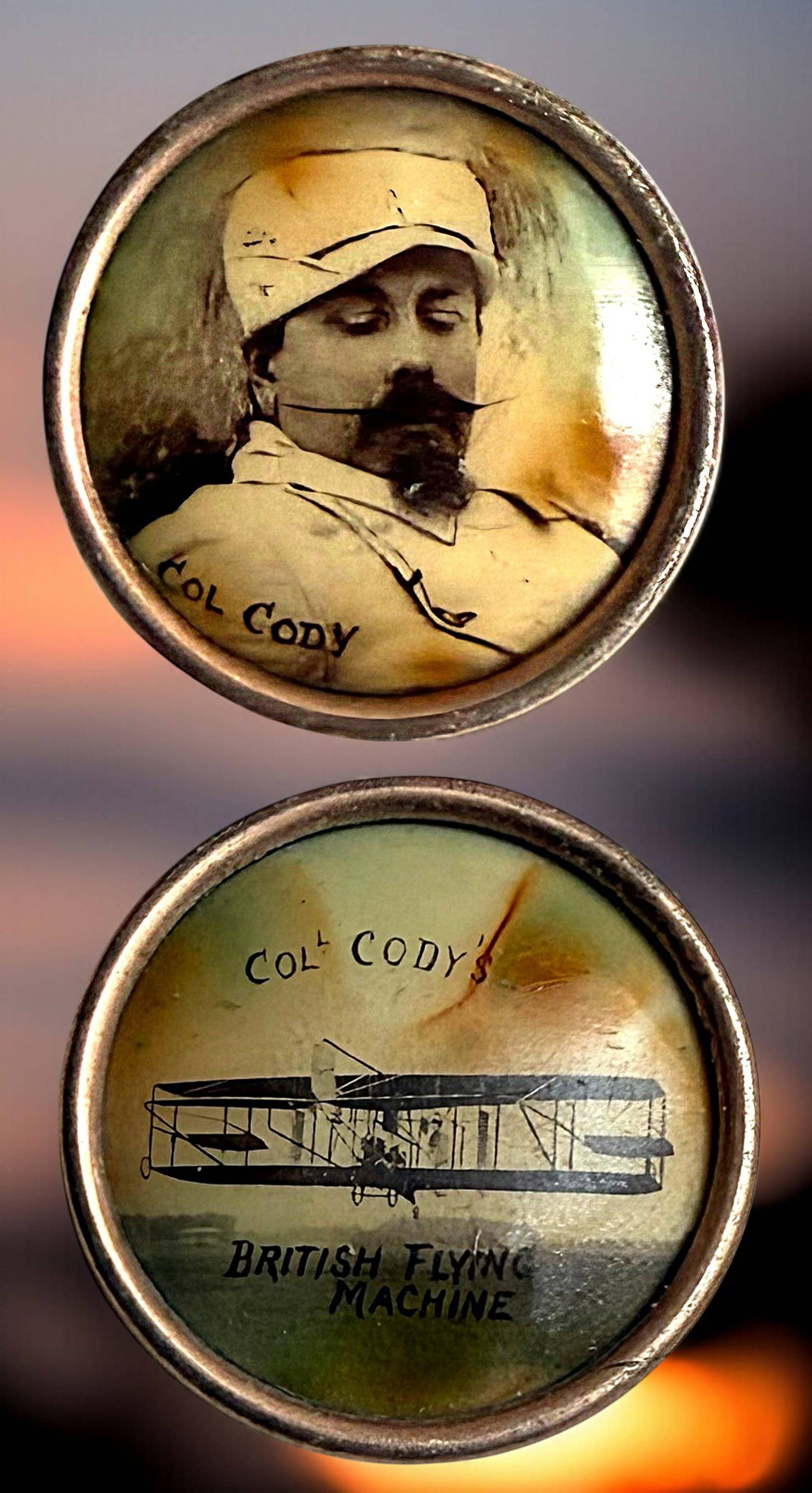 A RARE PAIR OF DIVISION ONE LITHO BUTTONS: 2 Small early 20th C. buttons of Samuel Cody and his airplane. These two hard to find buttons come on a laminated board with a description of them by the late Jeff Lee of Ohio. They are celluloid coat